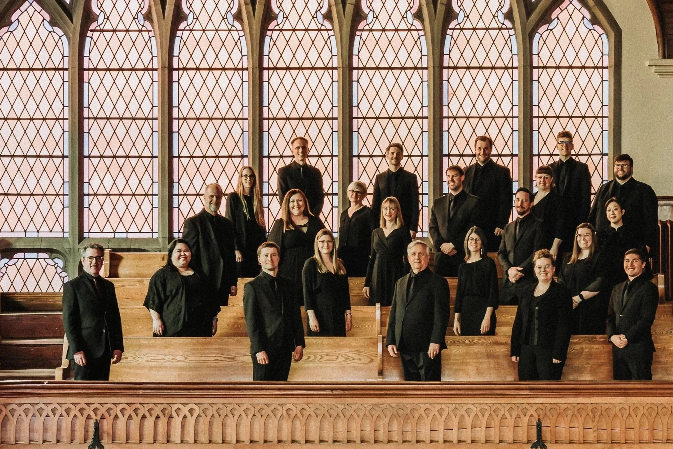 Photo of the choir, dressed in uniform and posed at McDougall United Church, in Edmonton AB.