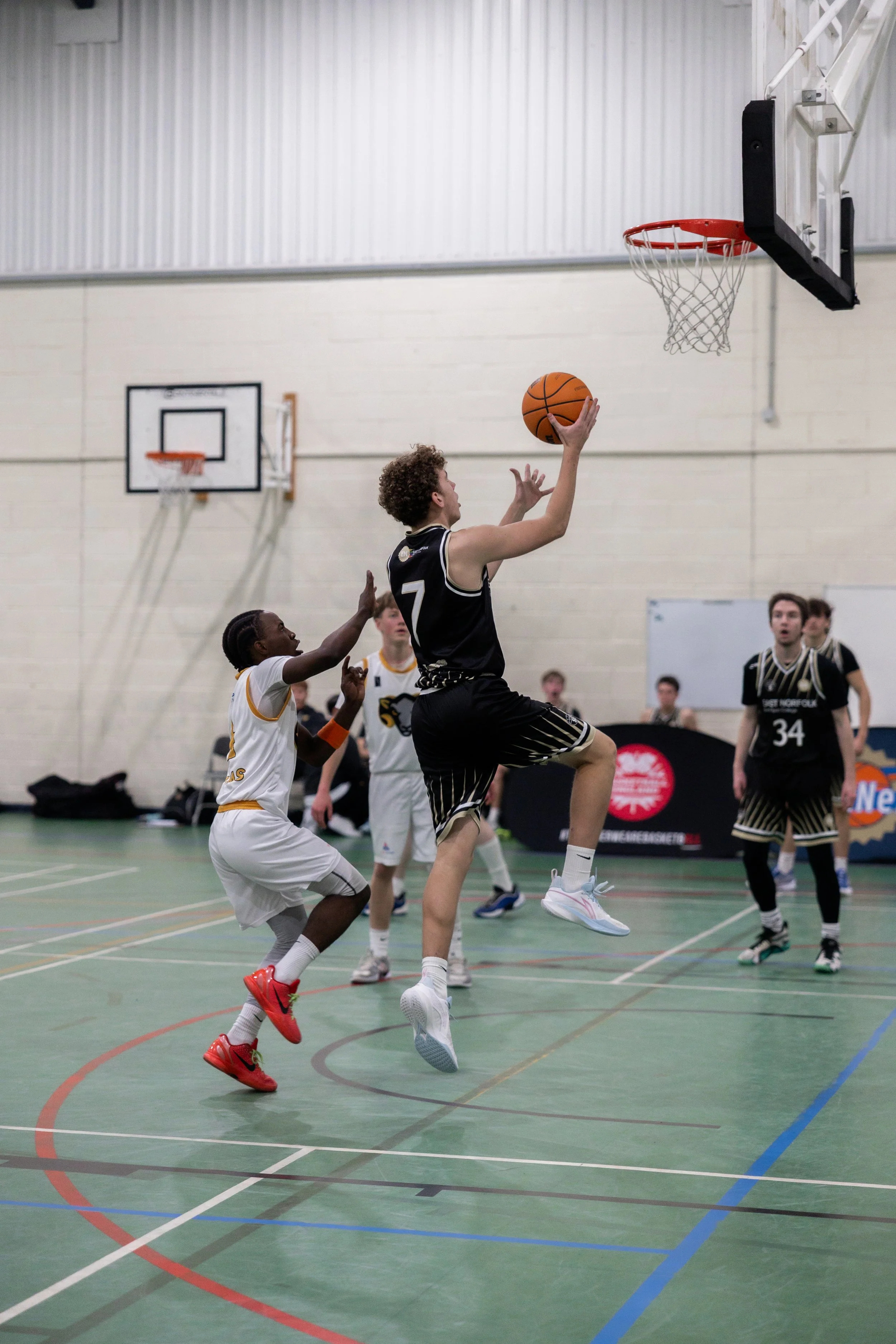 East Norfolk Basketball Academy player representing Great Yarmouth Basketball Club during a college basketball game.