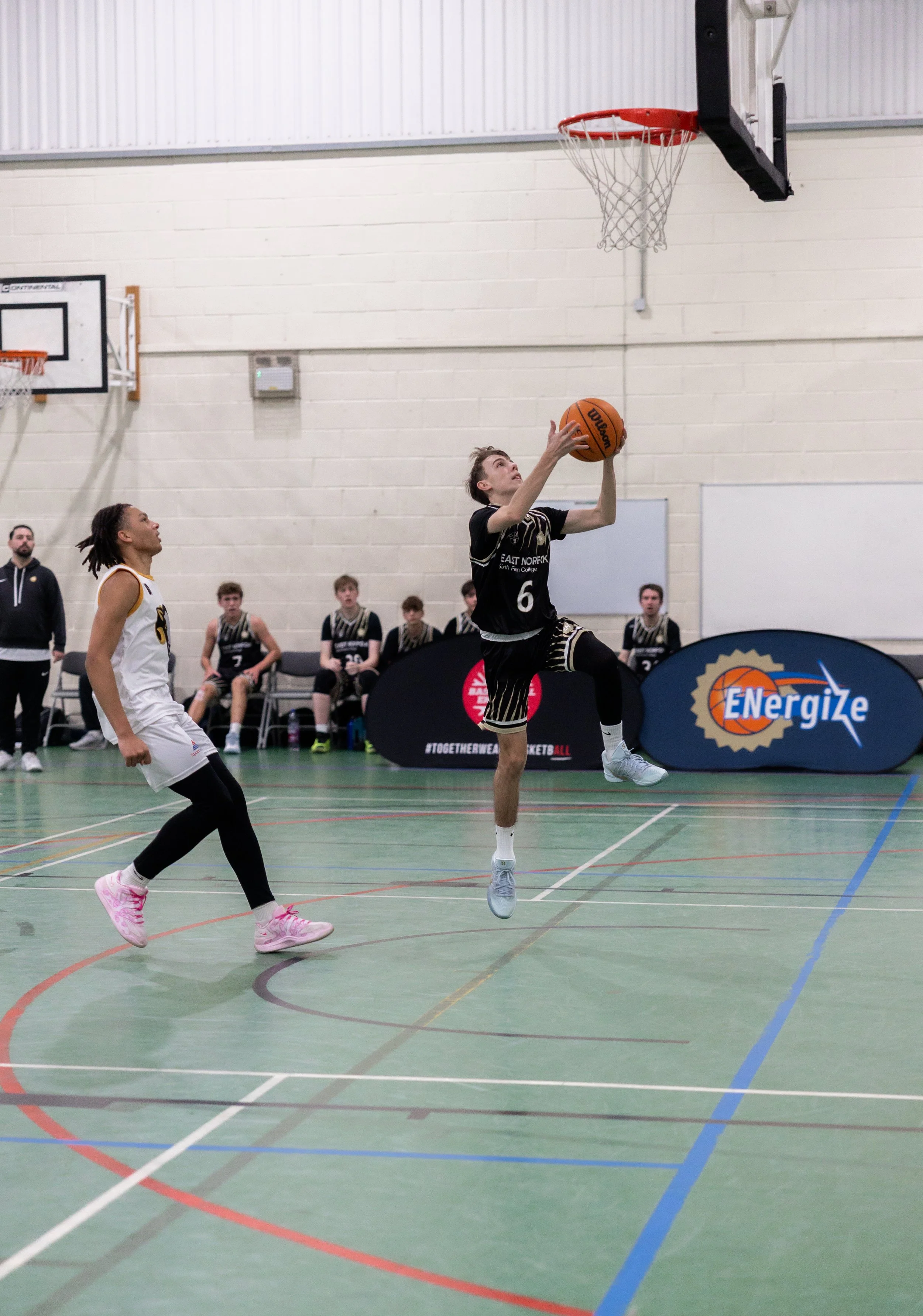 East Norfolk Basketball Academy player competing during a college basketball fixture.