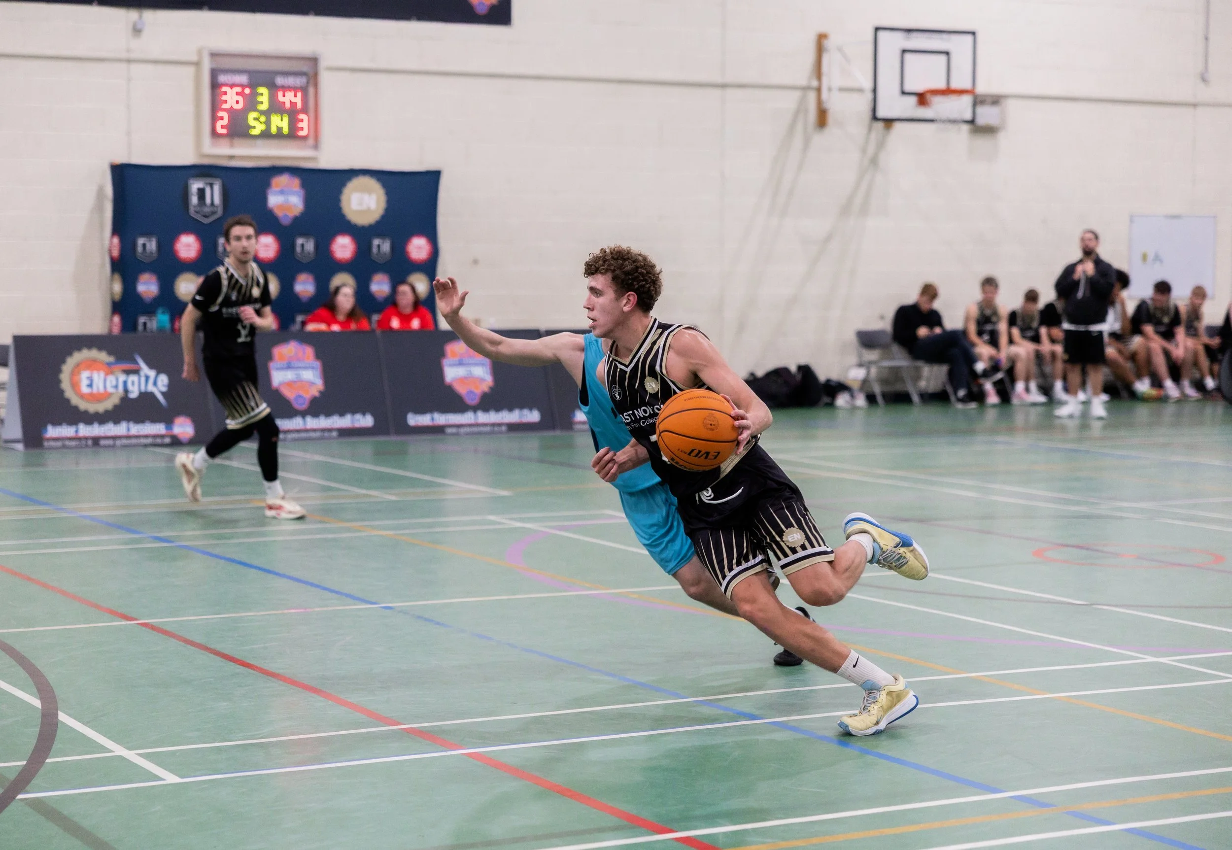 East Norfolk Basketball Academy player driving to the basket during an AOC academy fixture.