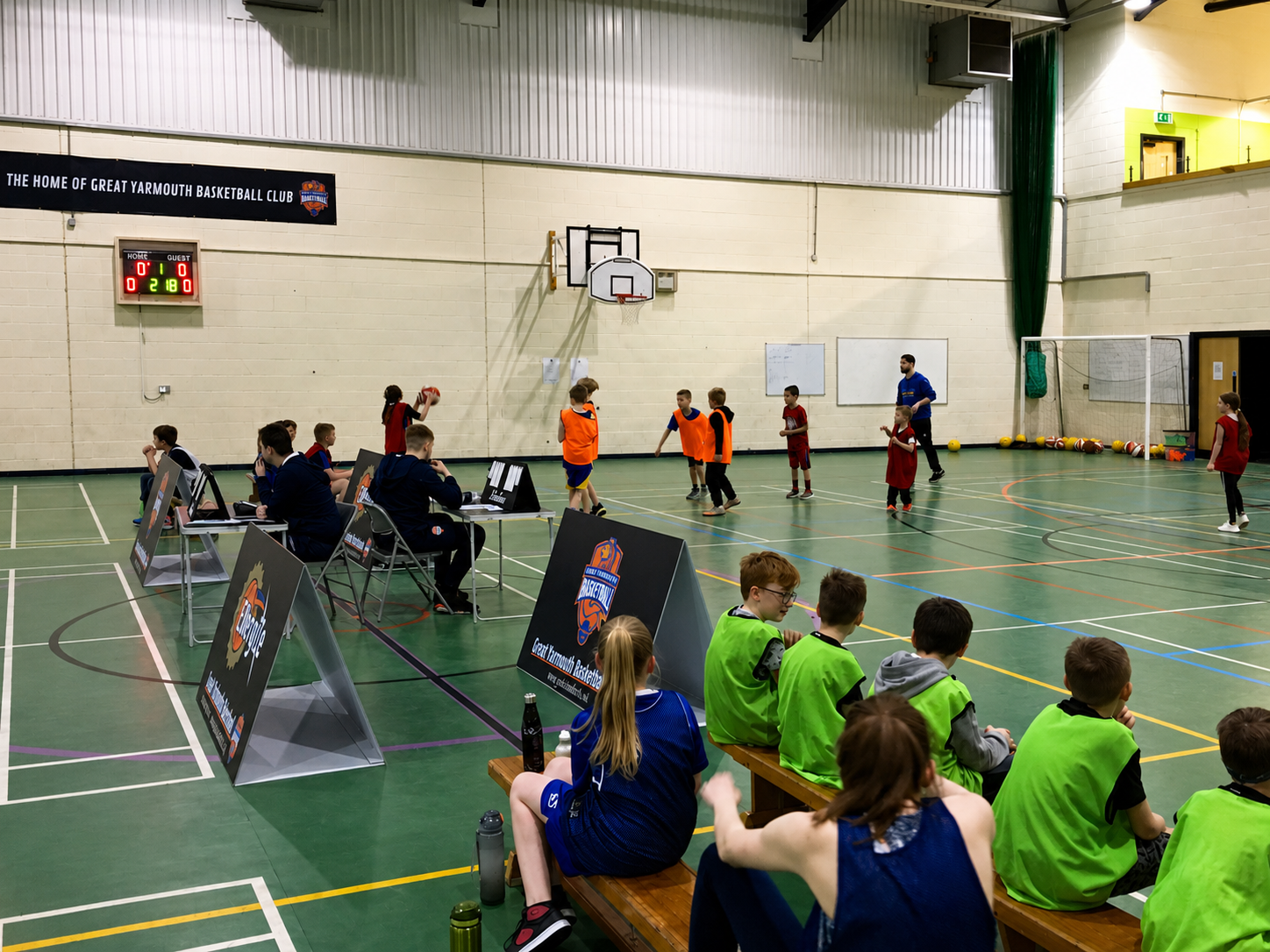 Young players playing basketball during a Great Yarmouth Basketball Club school holiday camp.