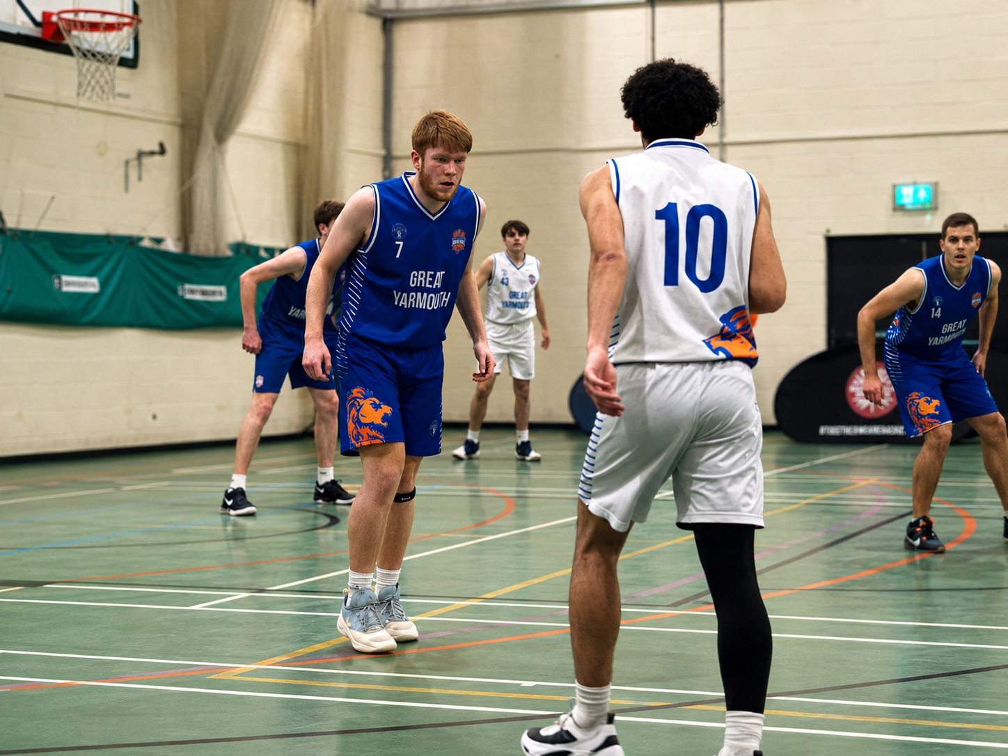 Great Yarmouth men’s basketball player defending during a game.