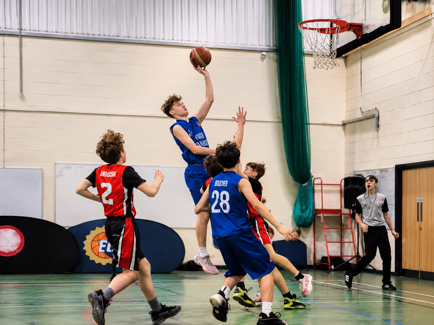 Great Yarmouth Basketball Club junior player shooting during a competitive game.