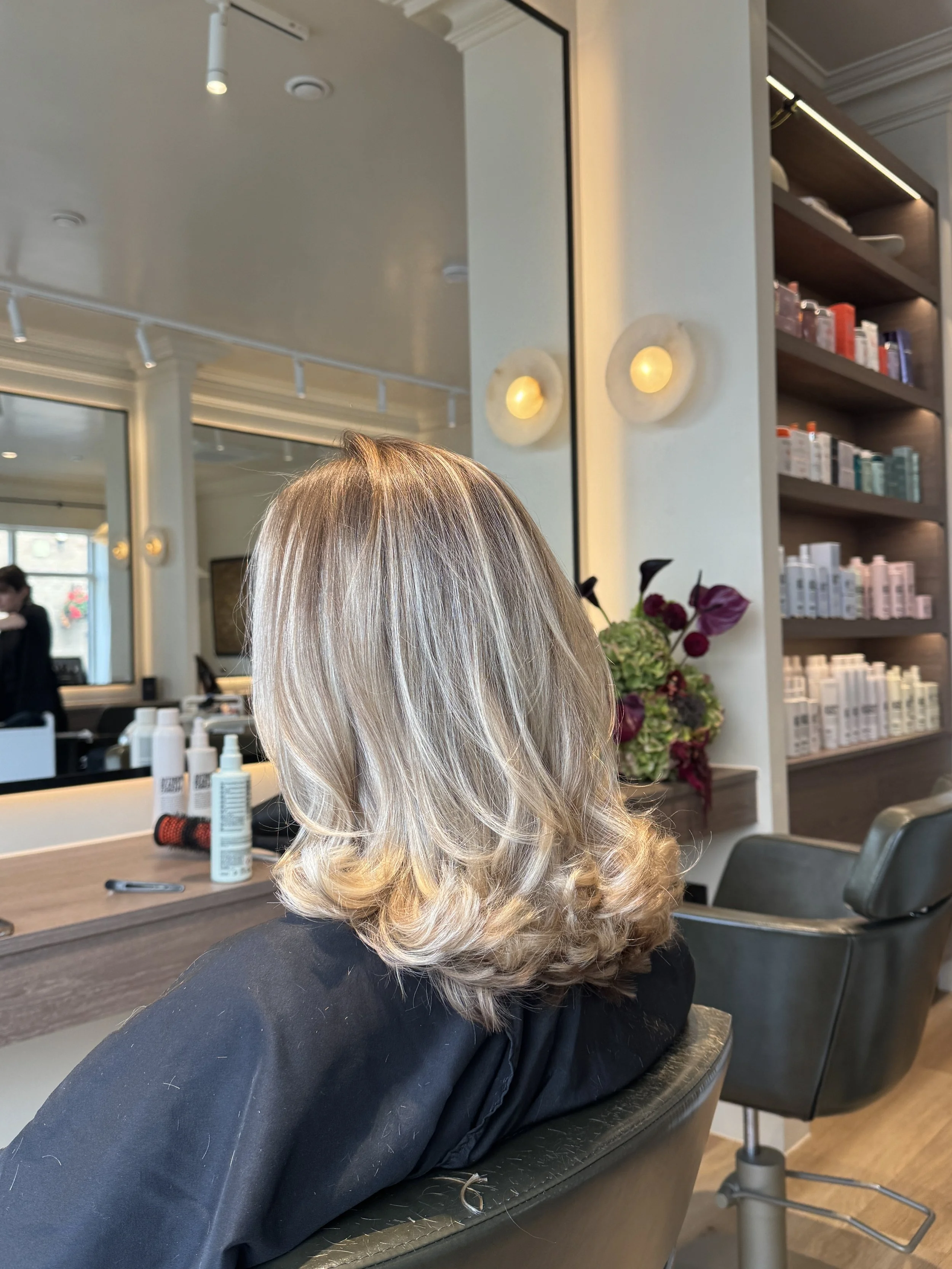 Softly styled blonde hair finished with a smooth blow-dry at Carmen Walker hair salon