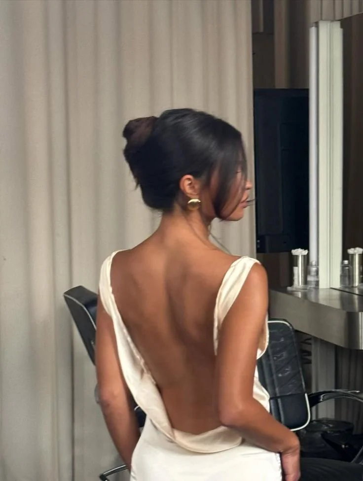 Sleek low up-do with a smooth finish, styled for a formal evening event