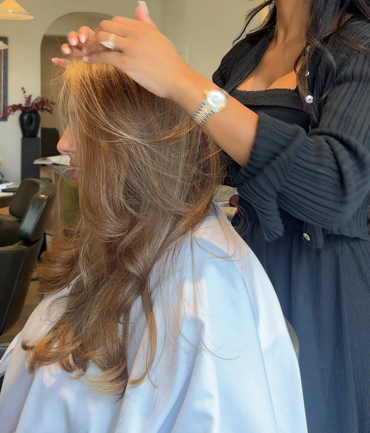 Close-up of stylist shaping hair during a blow-dry and colour appointment at Carmen Walker