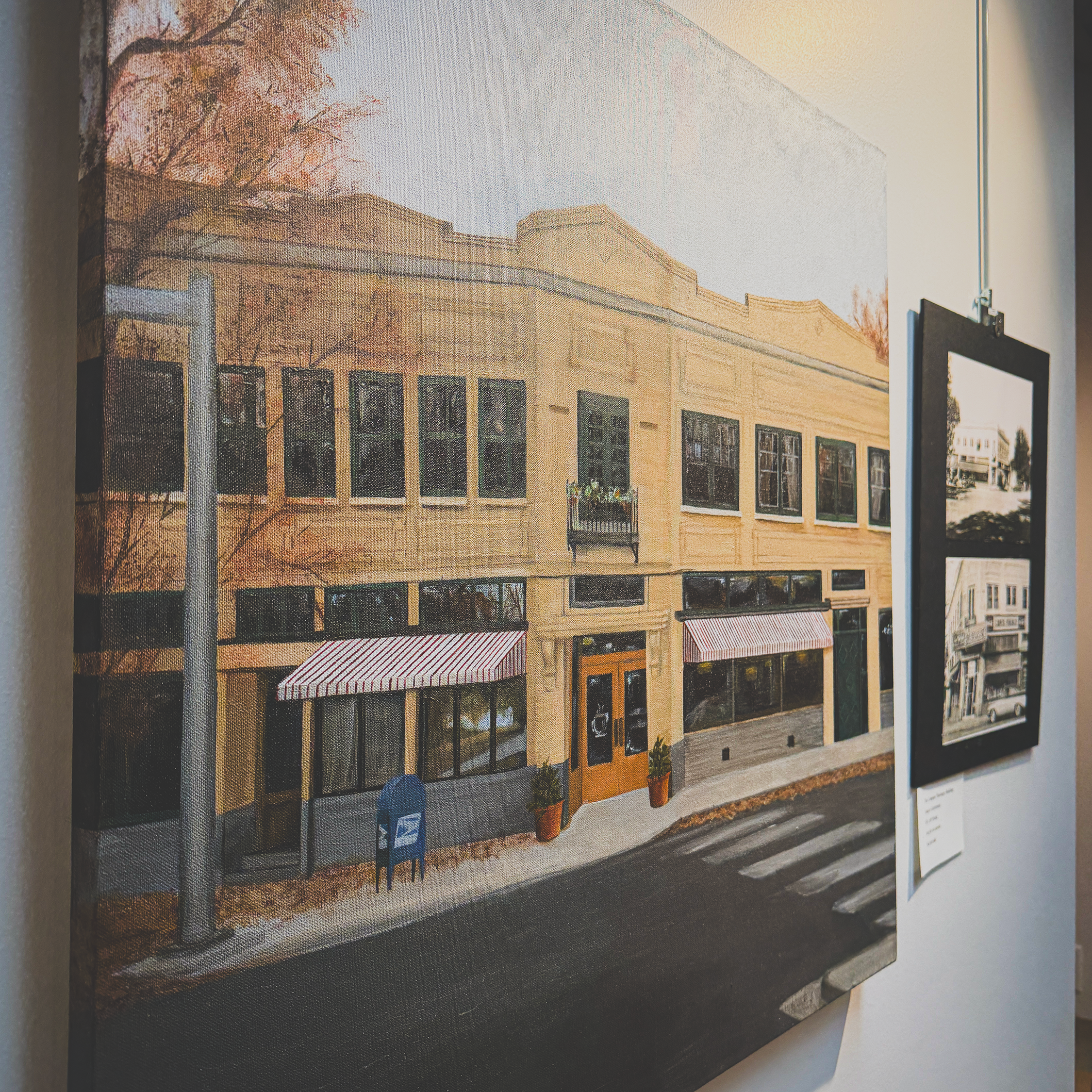  This realistic painting depicts the historic building on the corner of 16th Street and 10th Ave in downtown Greeley. The home of Margie’s Java Joint, the building has cream bricks, green trim, striped awnings, wooden double doors and wrap-around win