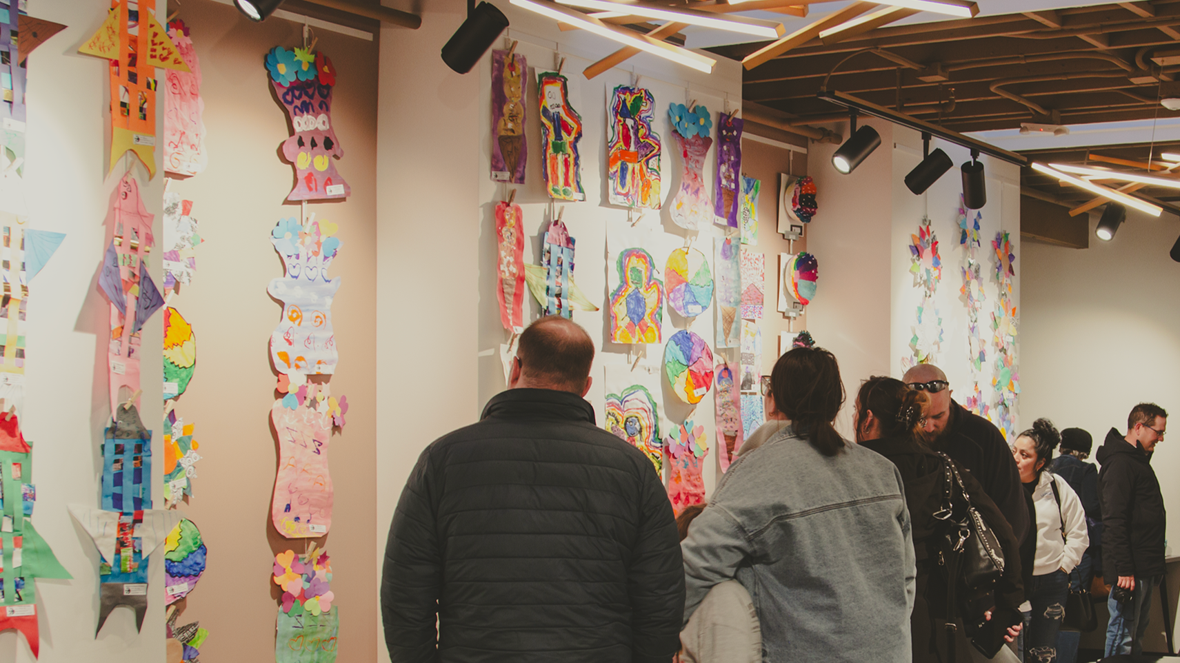 A family explores colorful art on display in the Wardell Gallery.
