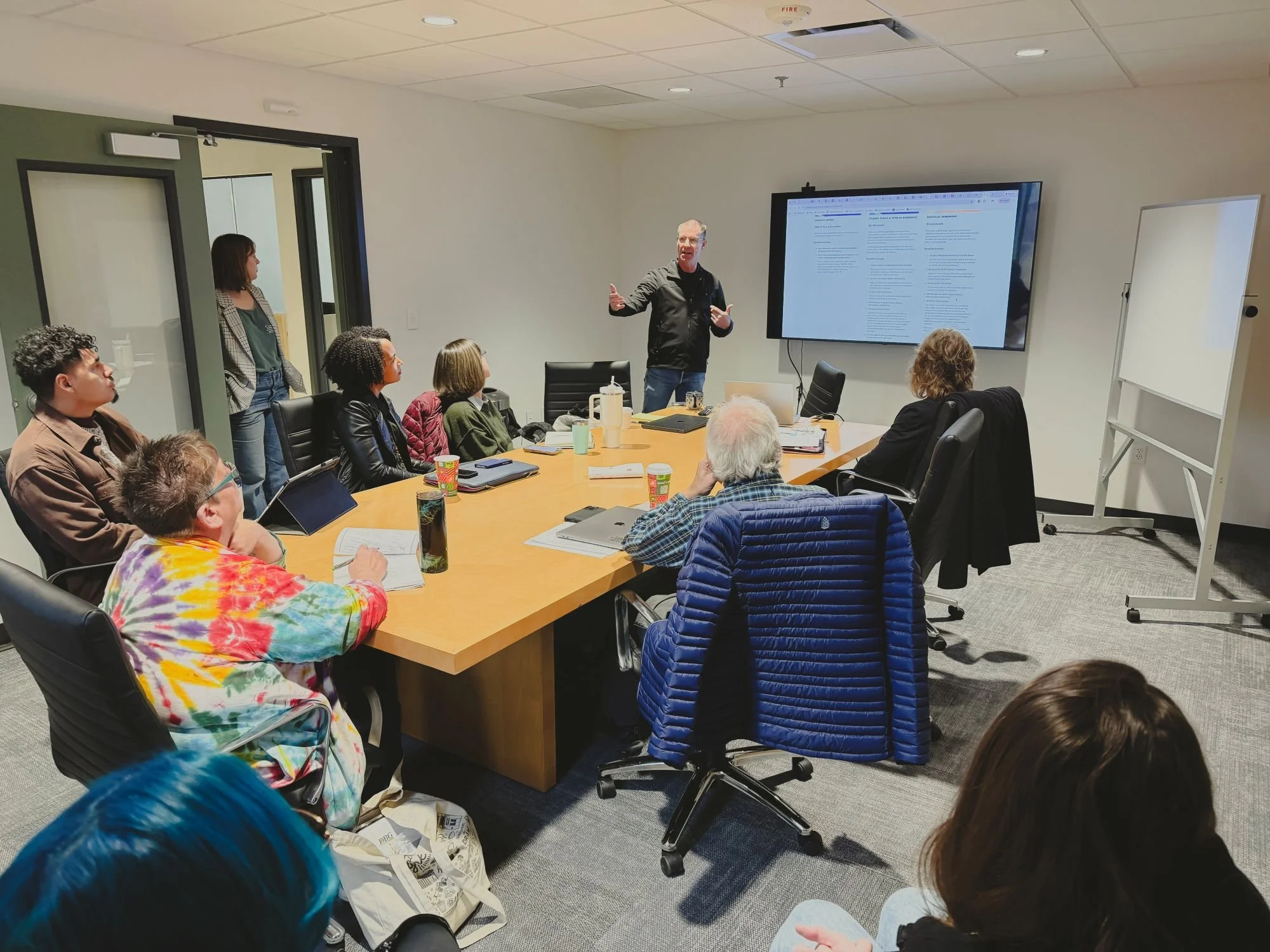 A man gives a presentation to fellow members of the GCD board.