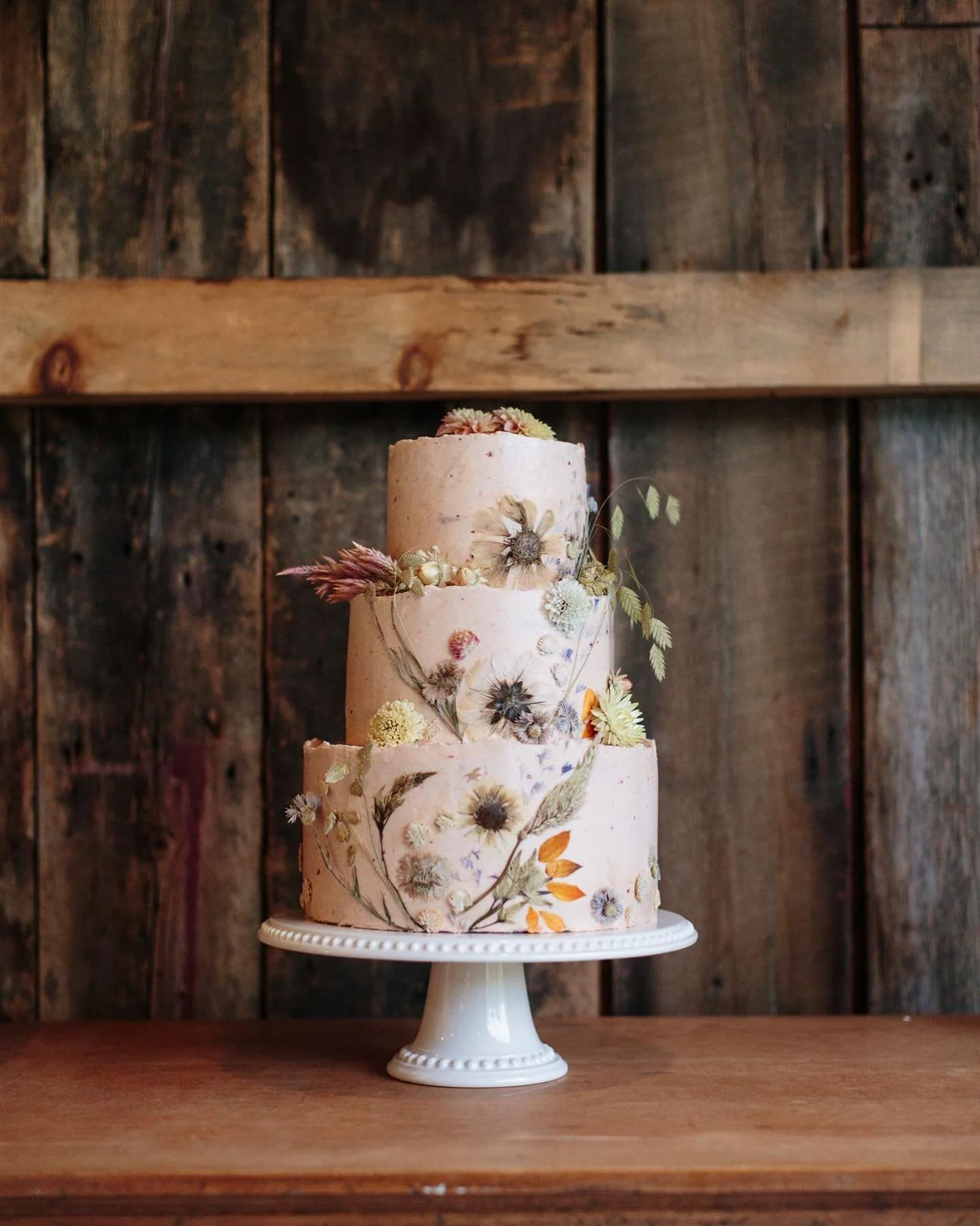 Top: lemon cake, lemon curd, strawberry buttercream 
Middle: lemon cake, lemon buttercream, strawberry compote 
Bottom: vanilla almond cake, strawberry compote, vanilla almond buttercream 
Exterior: strawberry buttercream 
Decorated with pressed and 