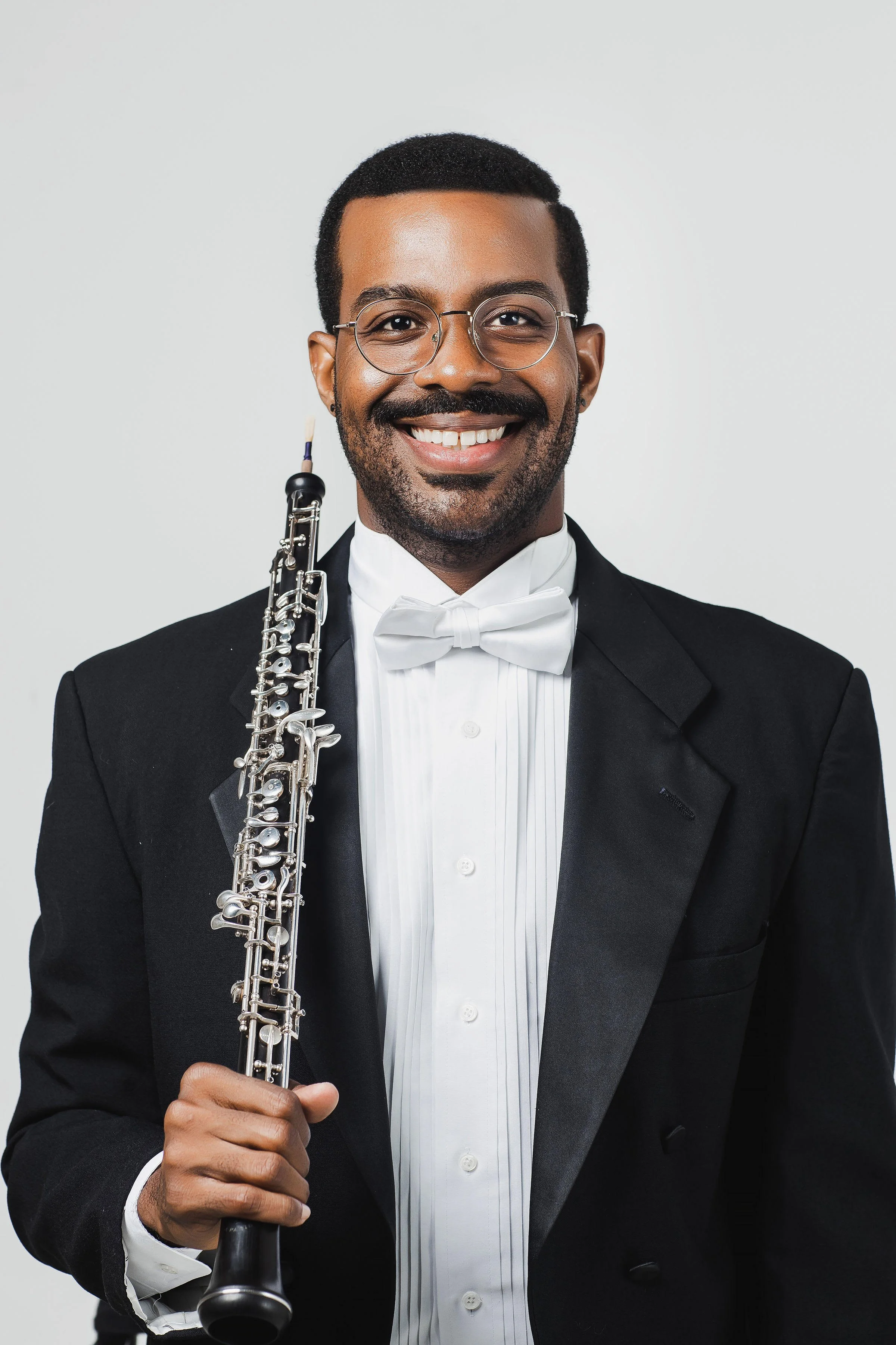Titus Underwood headshot with oboe