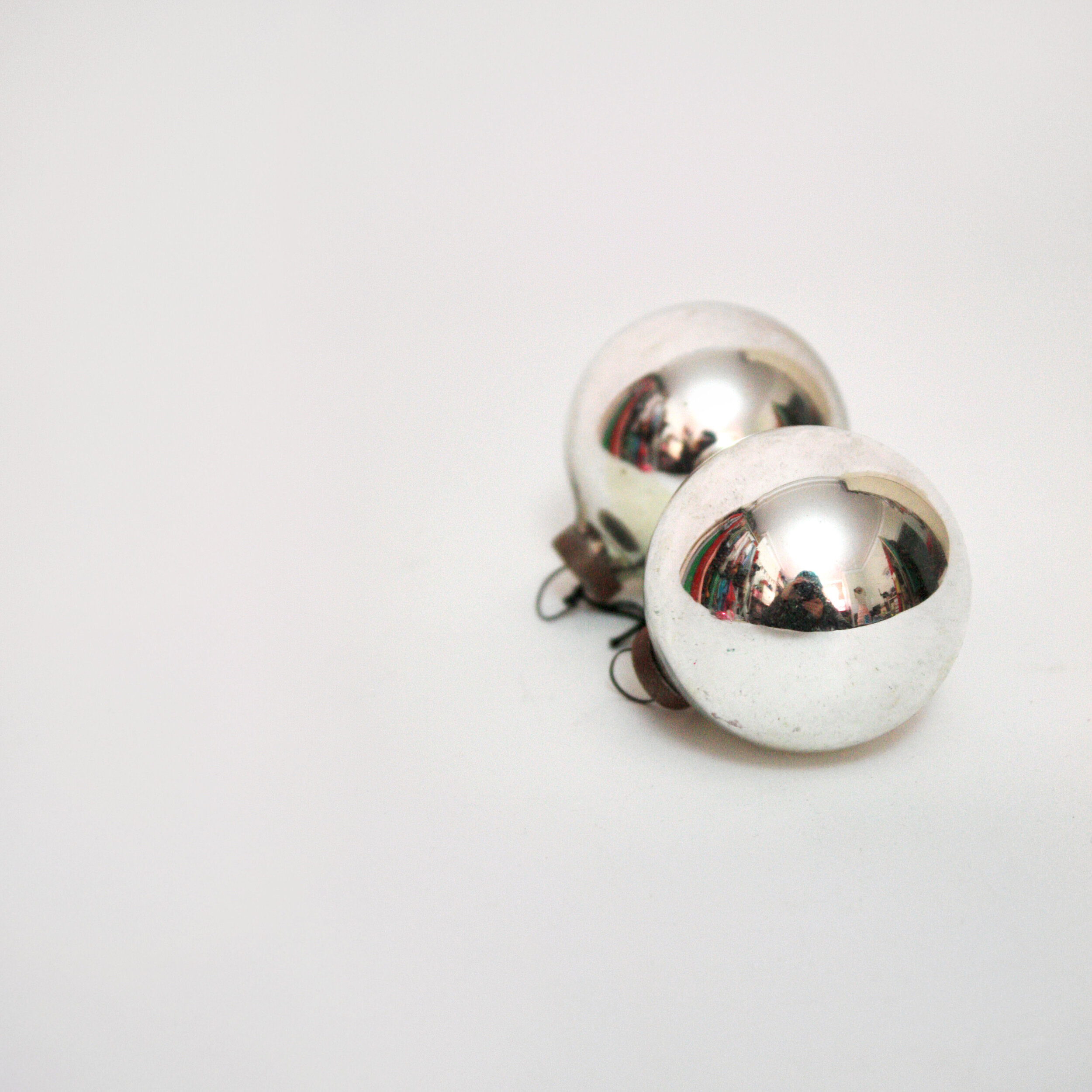 Pair of silver vintage glass baubles