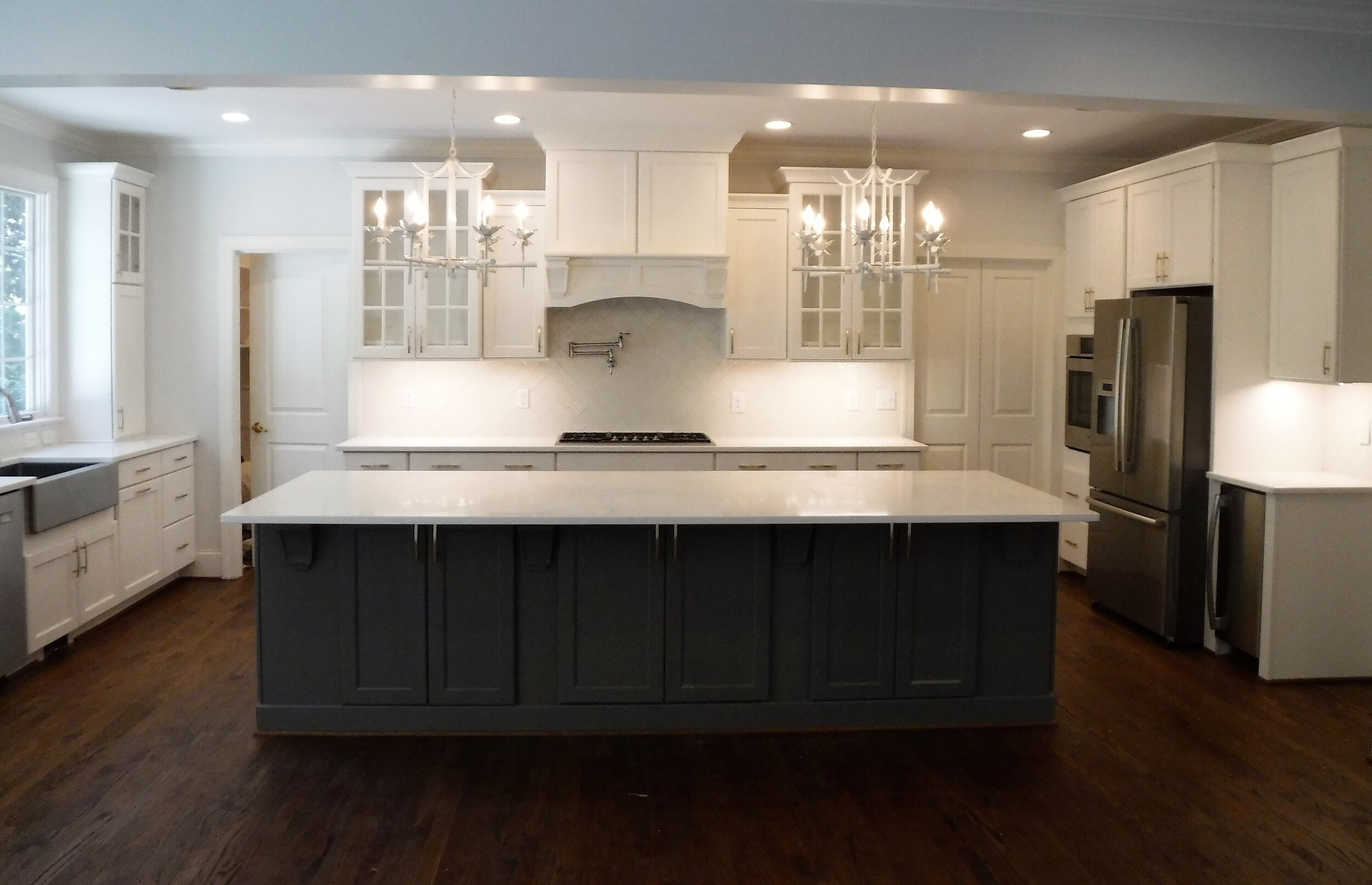 The kitchen includes a large island with seating, quartz countertops, an ice maker and plenty of room for entertaining.