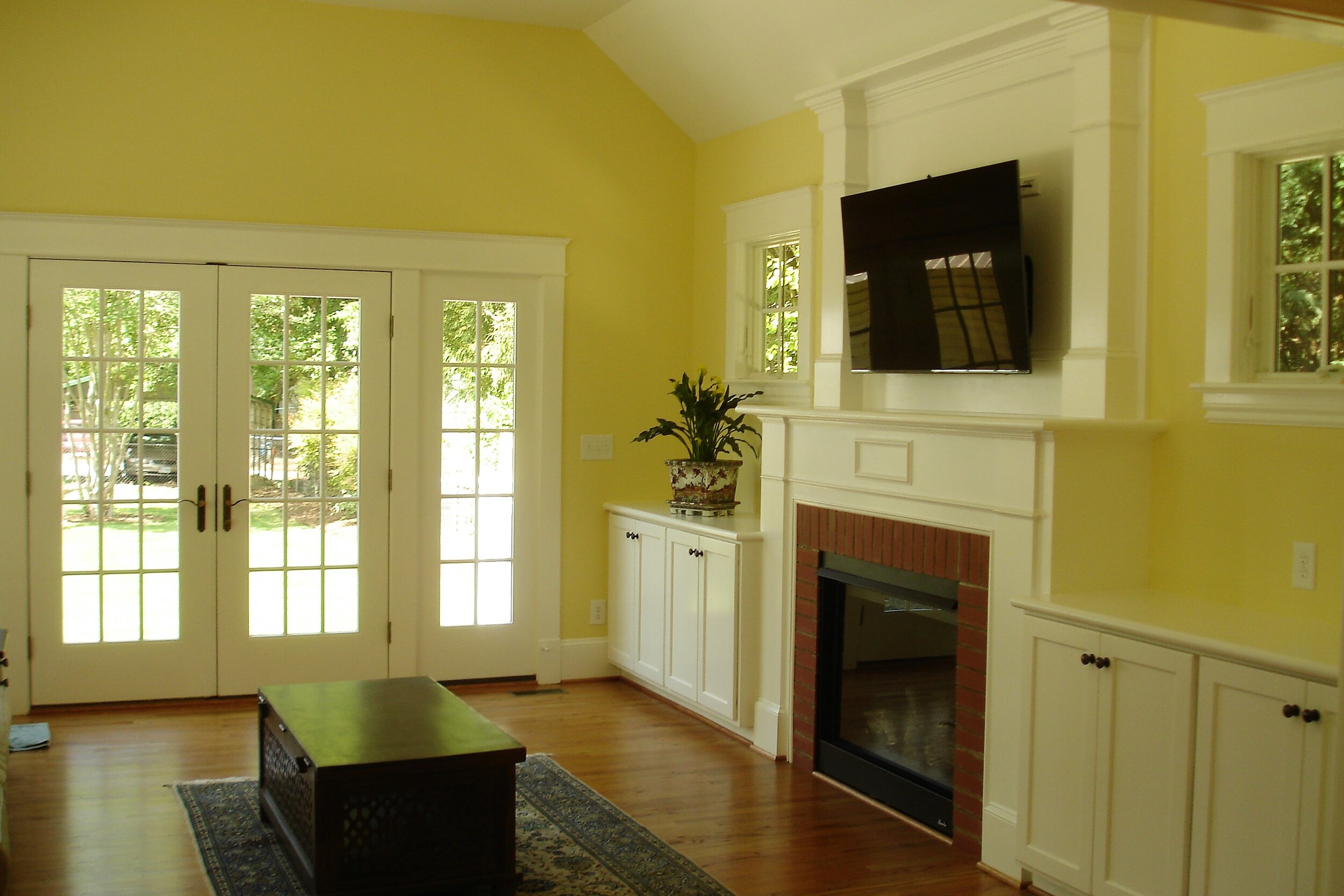 The family room features a gas fireplace and semicustom  built cabinetry.