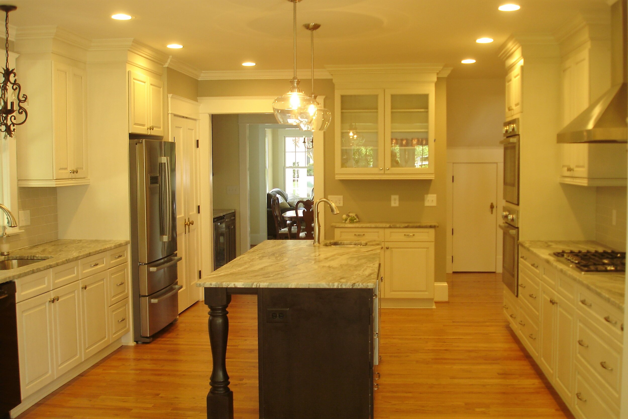 The kitchen features an island with seating and granite countertops with  a leathered finish.