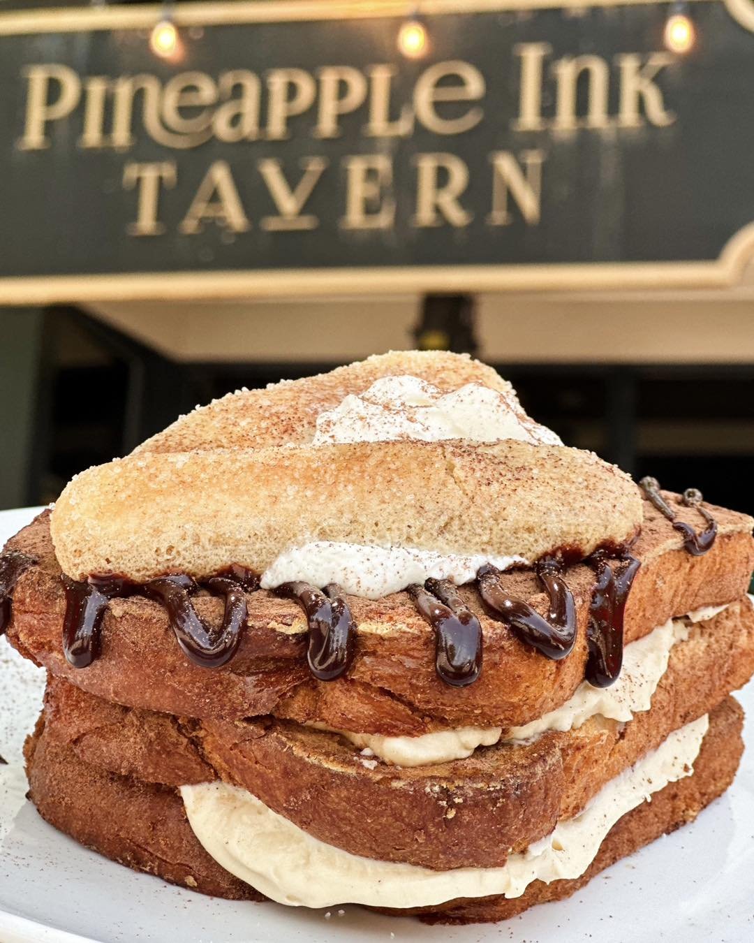 Come brunch with us and enjoy this irresistible Tiramisu French Toast! ☕🍫 Indulge in layers of espresso-soaked goodness topped with luscious mascarpone and lady fingers. Don't miss out! 

#WeekendBrunch #TiramisuDelight #PineappleInkTavern