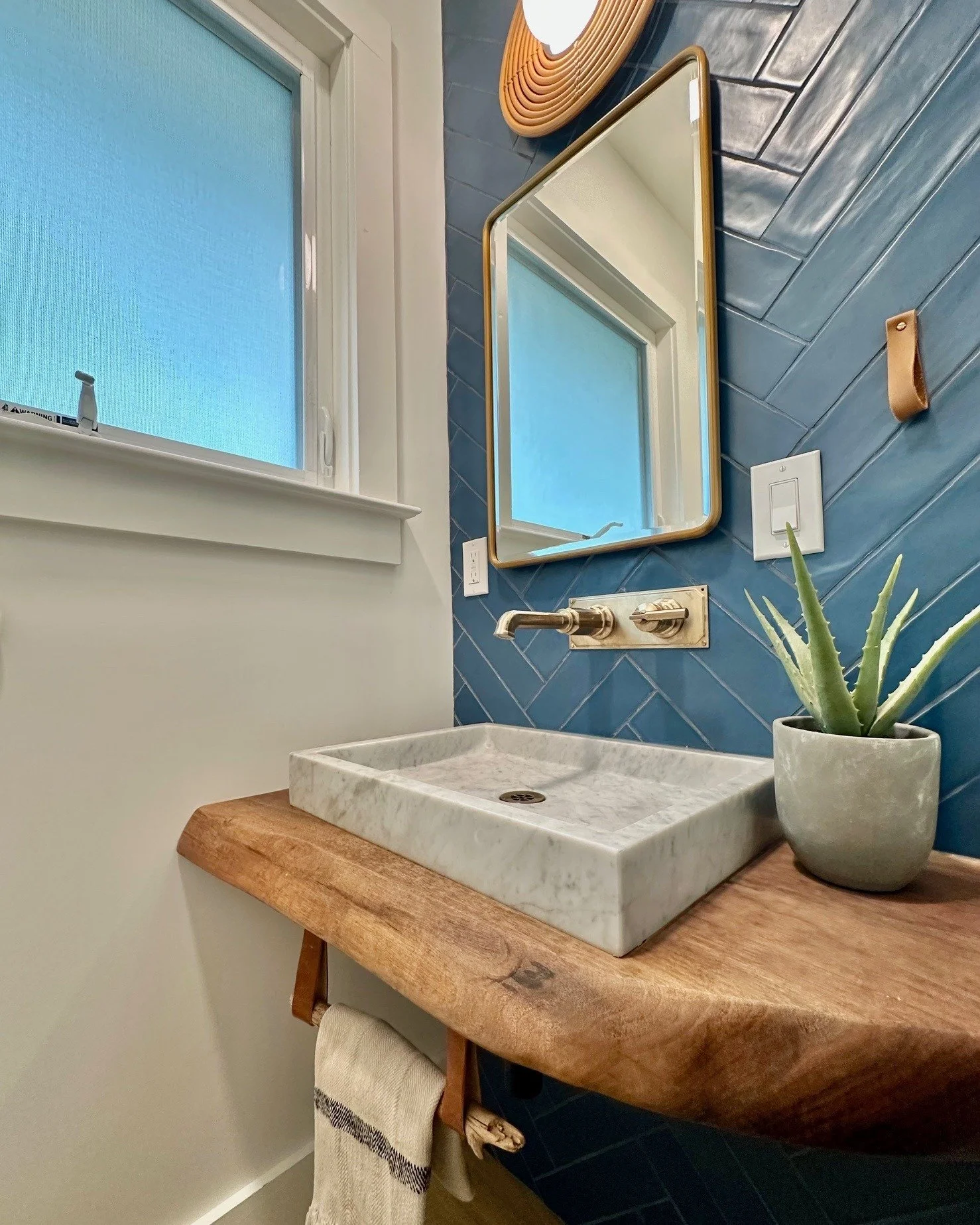 💙 "The sun is up, the sky is blue. It's beautiful, and so are you." – John Lennon 💙
Who says earthy design has to be neutral? This powder room transformation we designed in Lafayette proves that bold color and natural elements can