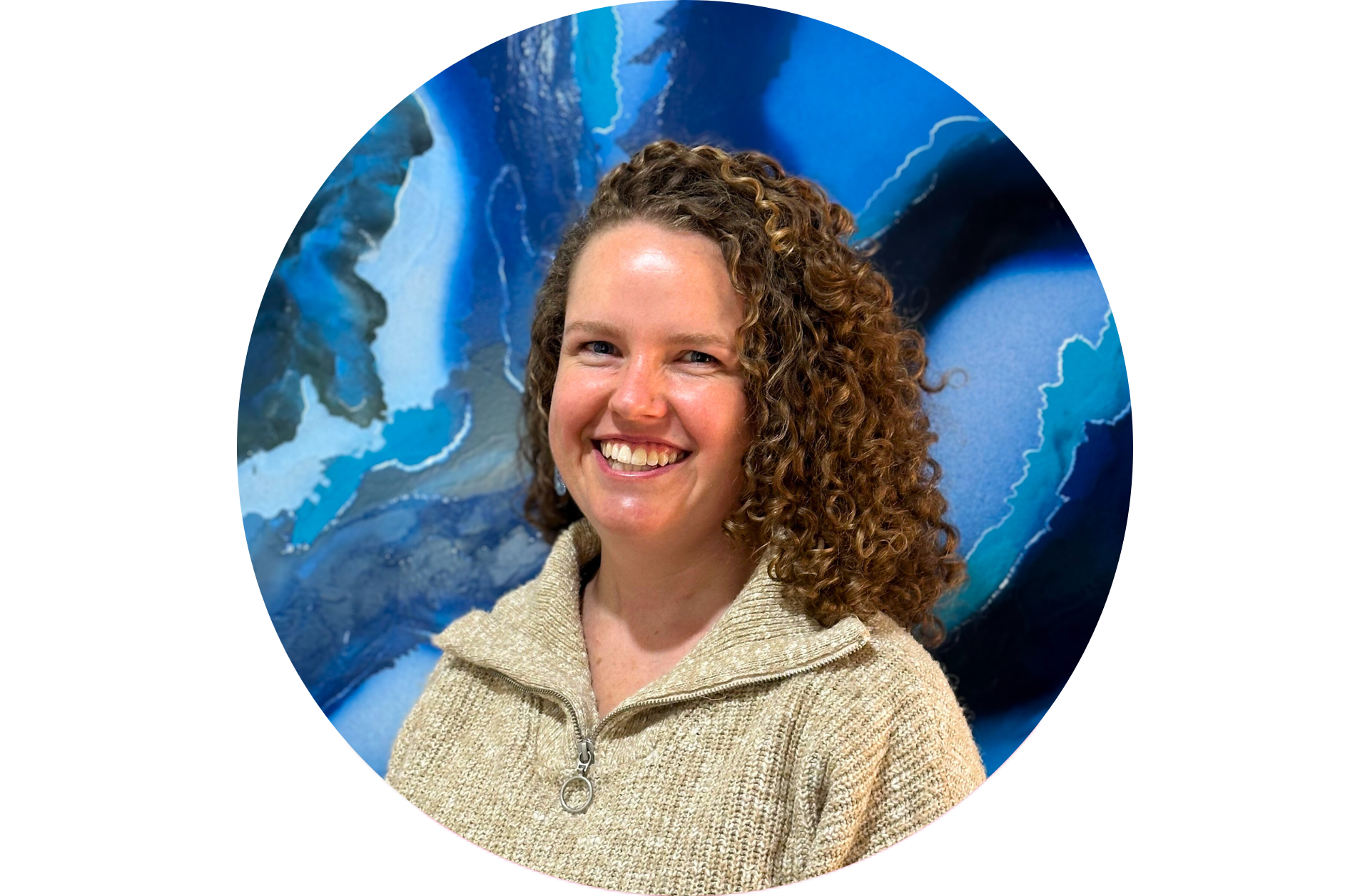 Smiling person with curly hair in front of blue abstract background
