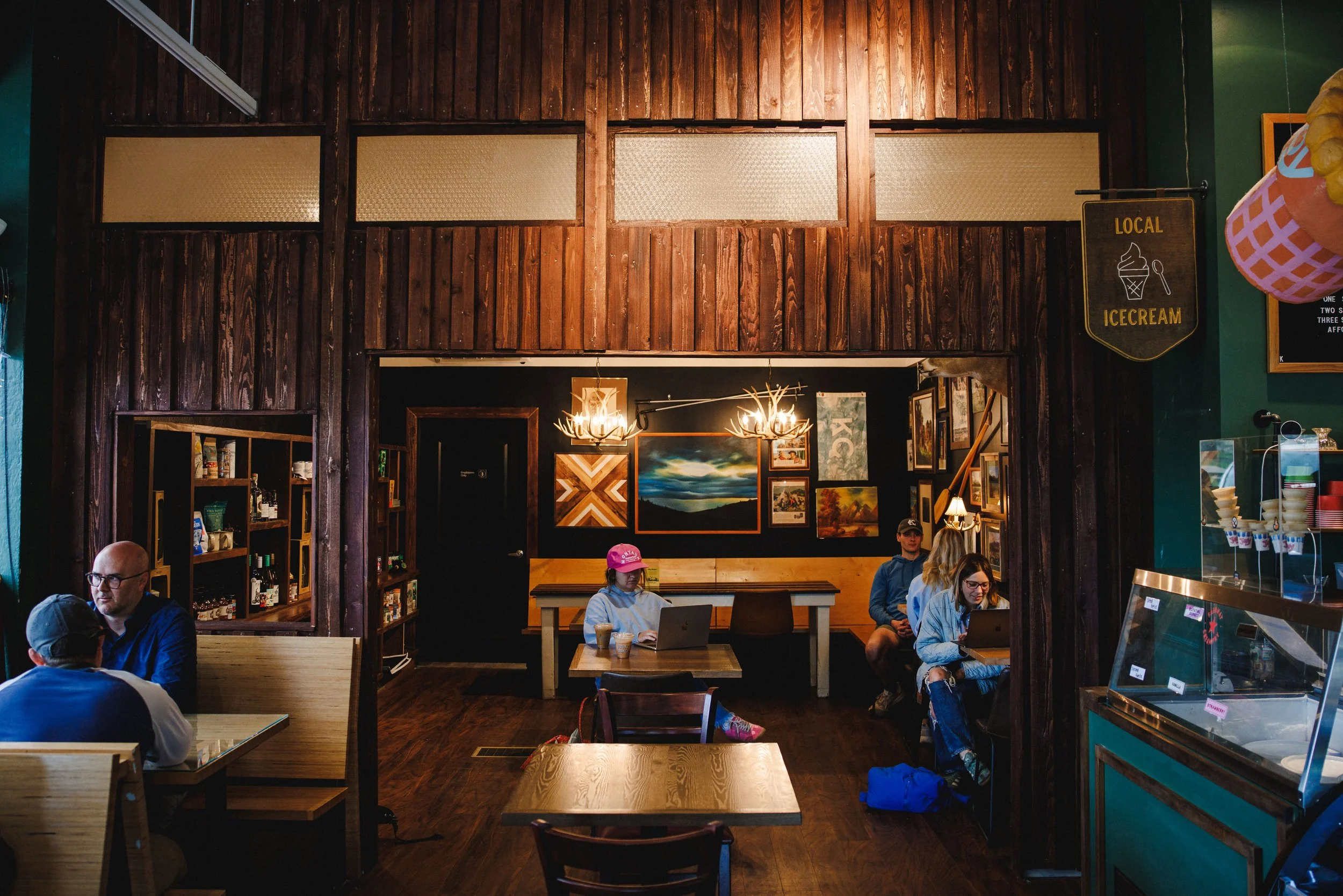 The main room at Front Range KC, with booths, big tables and green walls
