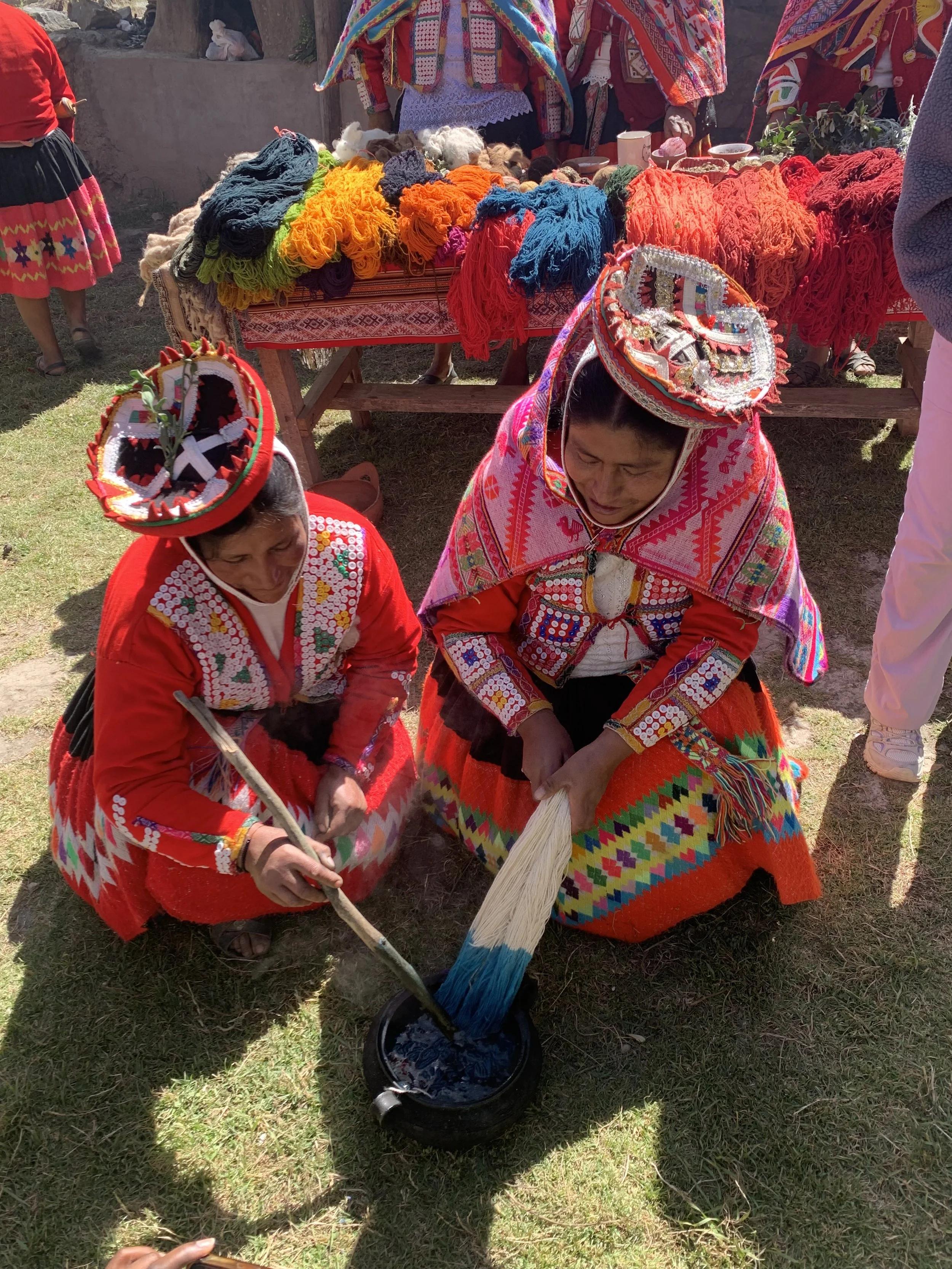 Two Quechua artisans demo a blue natural dye