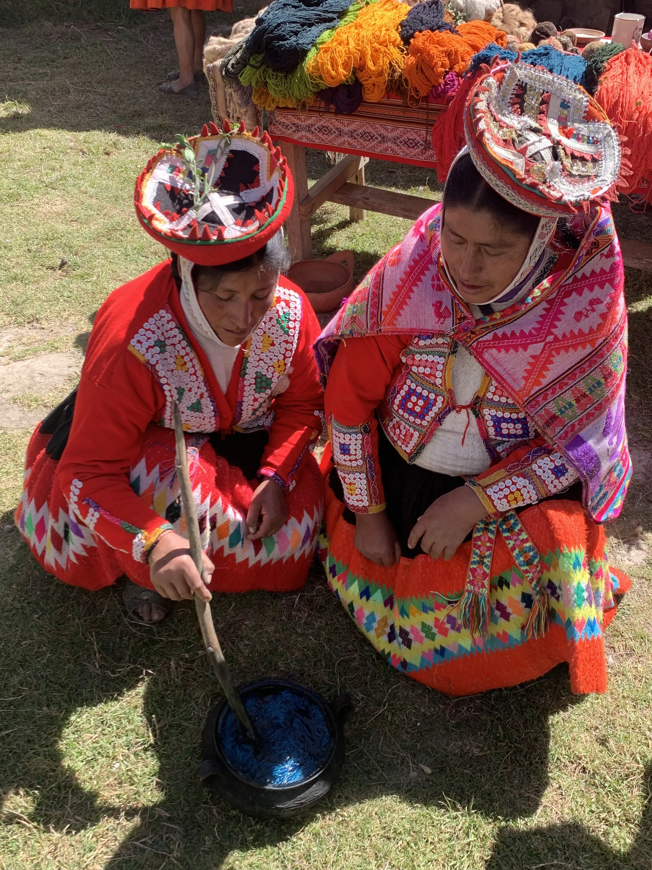 Quechua artisans demonstrating blue natural dyed yarn