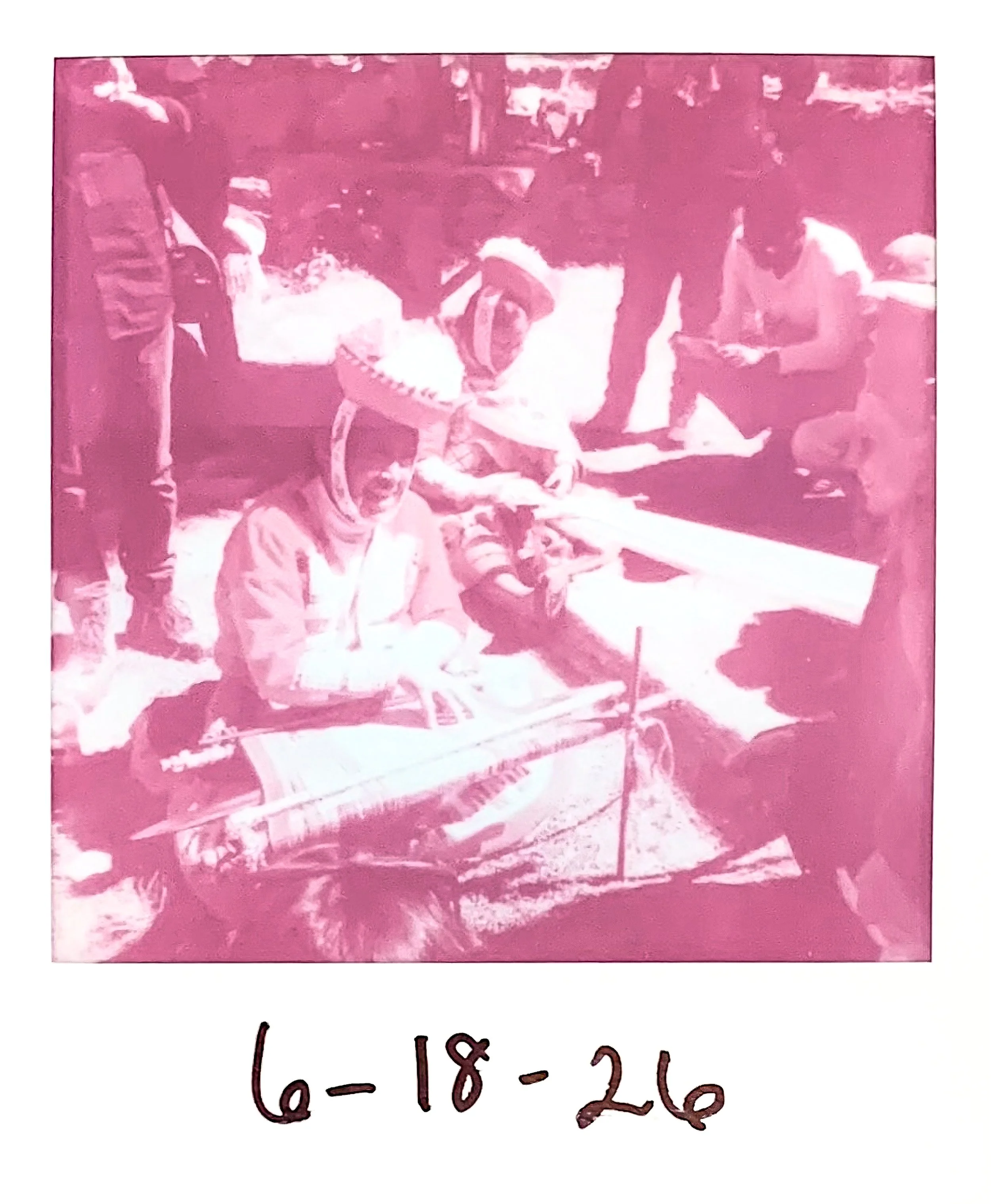 A pink-tinted photograph shows Quechua weavers weaving on a backstrap loom. The scene appears to be a community event that is dated '6-18-26'.