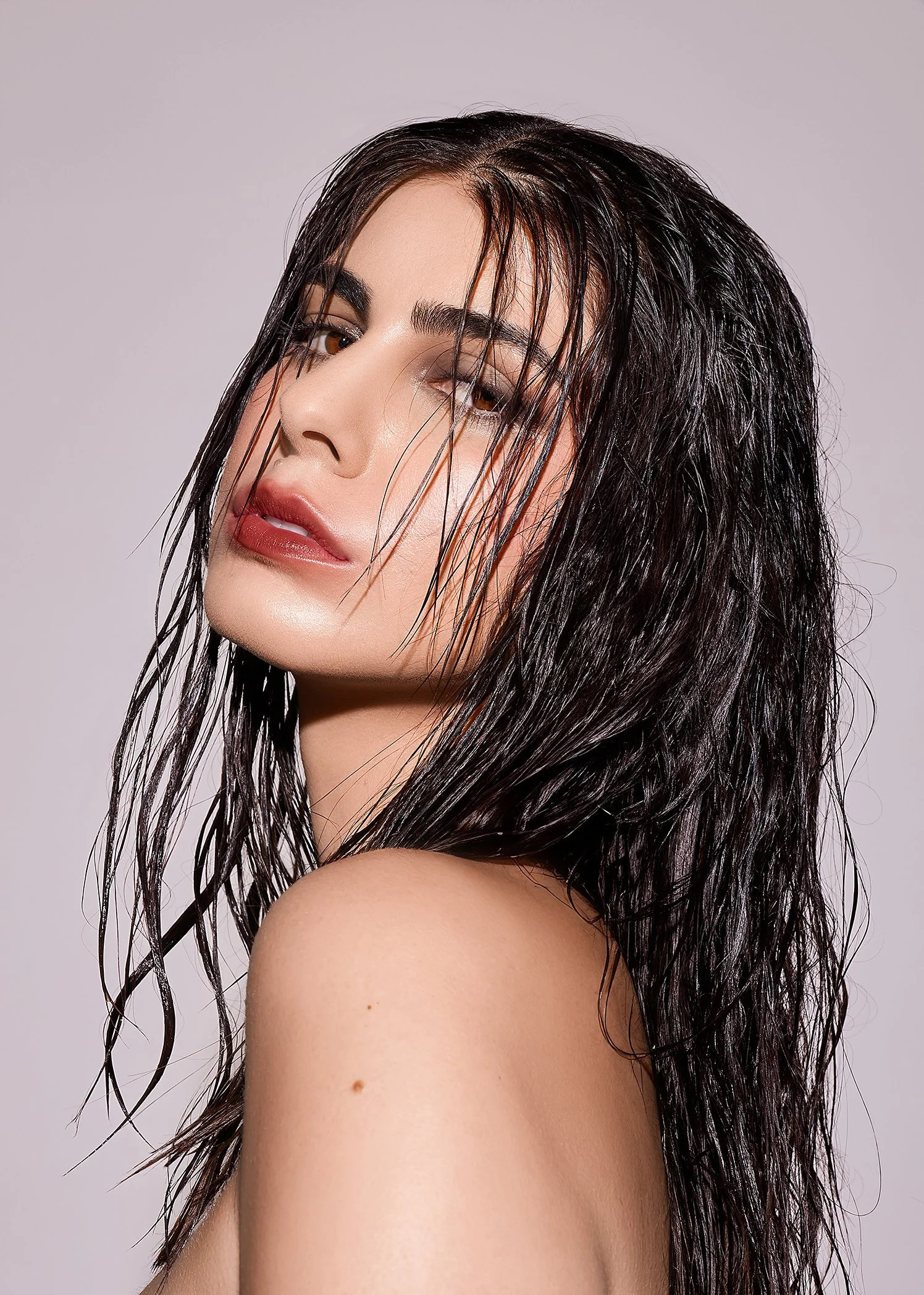 Portrait of a woman with wet hair and red lipstick.