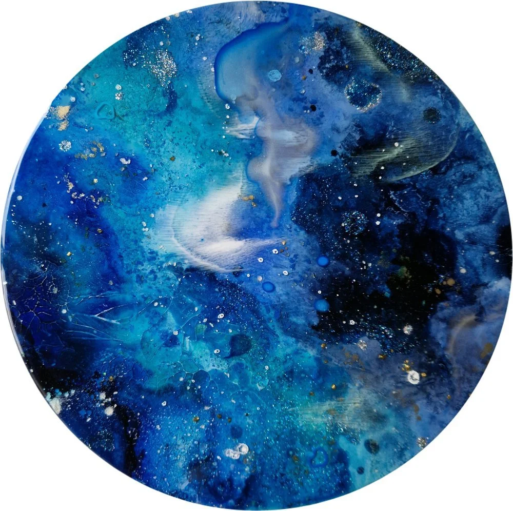 Circular blue resin abstract art with shades of blue, white, and black, ocean resin art, ocean epoxy art, ocean art, coastal decor, coastal art. Original bespoke abstract artwork created by artist Katie Alize, based in UK, Essex, London.