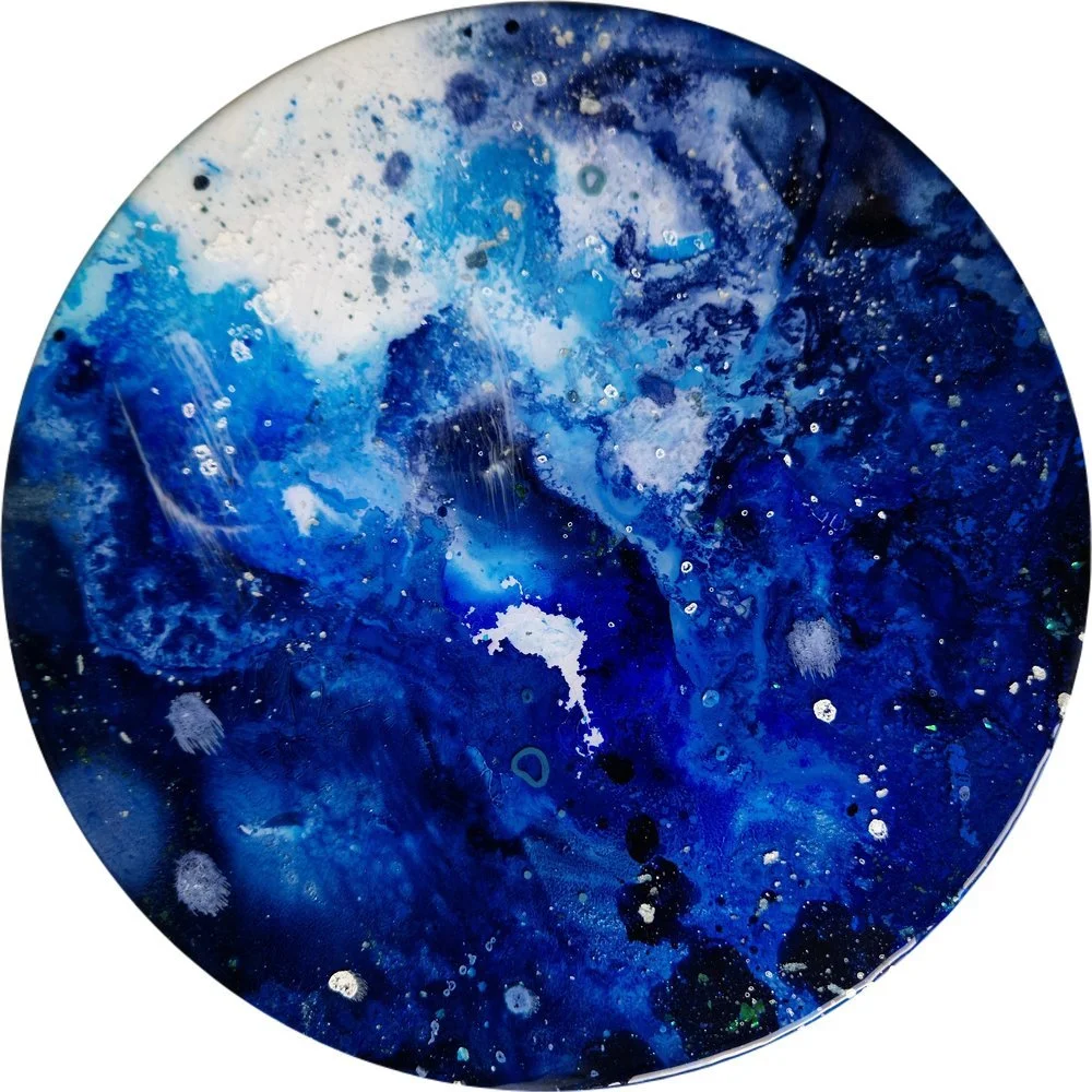 Circular blue resin abstract art with shades of blue, white, and black, ocean resin art, ocean epoxy art, ocean art, coastal decor, coastal art. Original bespoke abstract artwork created by artist Katie Alize, based in UK, Essex, London.