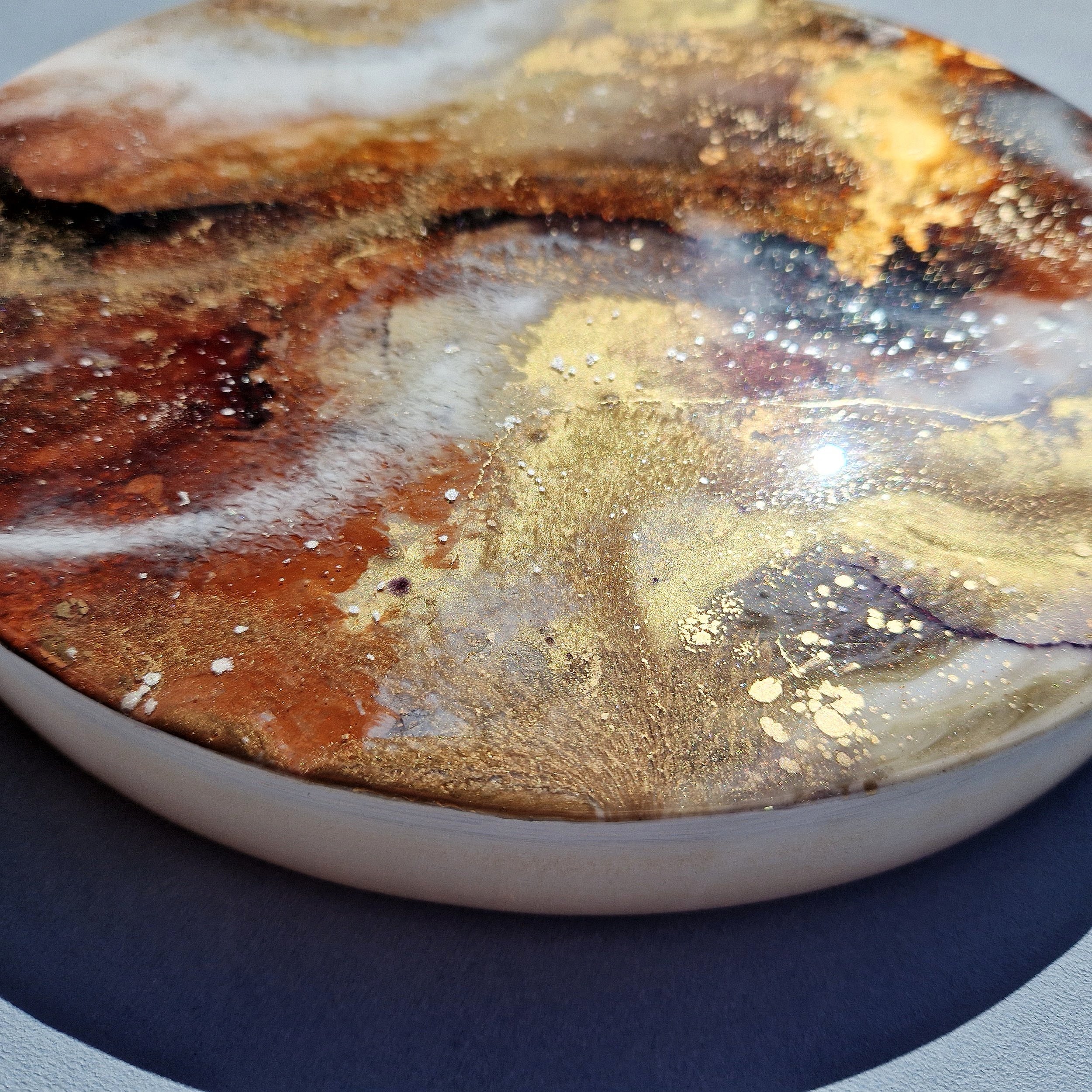 Coffee inspired round wall art inspired by the rich, warm hues of coffee. The piece is made from resin and mixed media materials. Perfect for adding a touch of organic art to any coffee lovers room.
