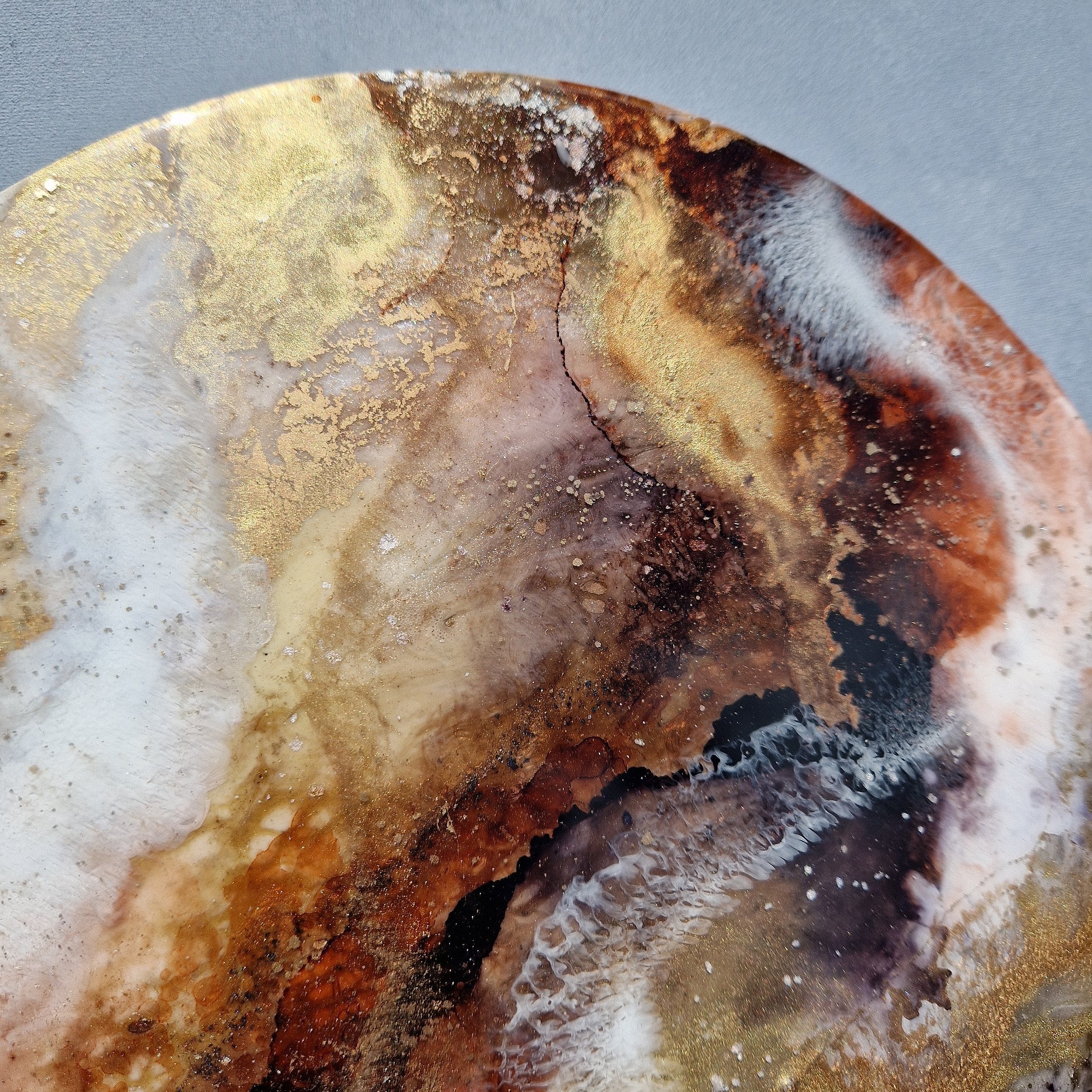 Coffee inspired round wall art inspired by the rich, warm hues of coffee. The piece is made from resin and mixed media materials. Perfect for adding a touch of organic art to any coffee lovers room.