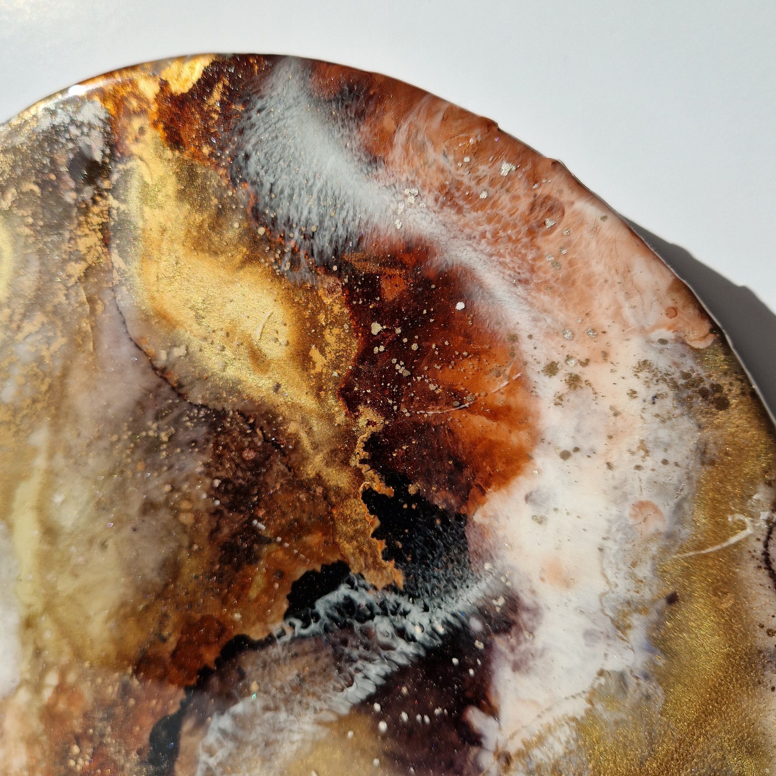 Coffee inspired round wall art inspired by the rich, warm hues of coffee. The piece is made from resin and mixed media materials. Perfect for adding a touch of organic art to any coffee lovers room.