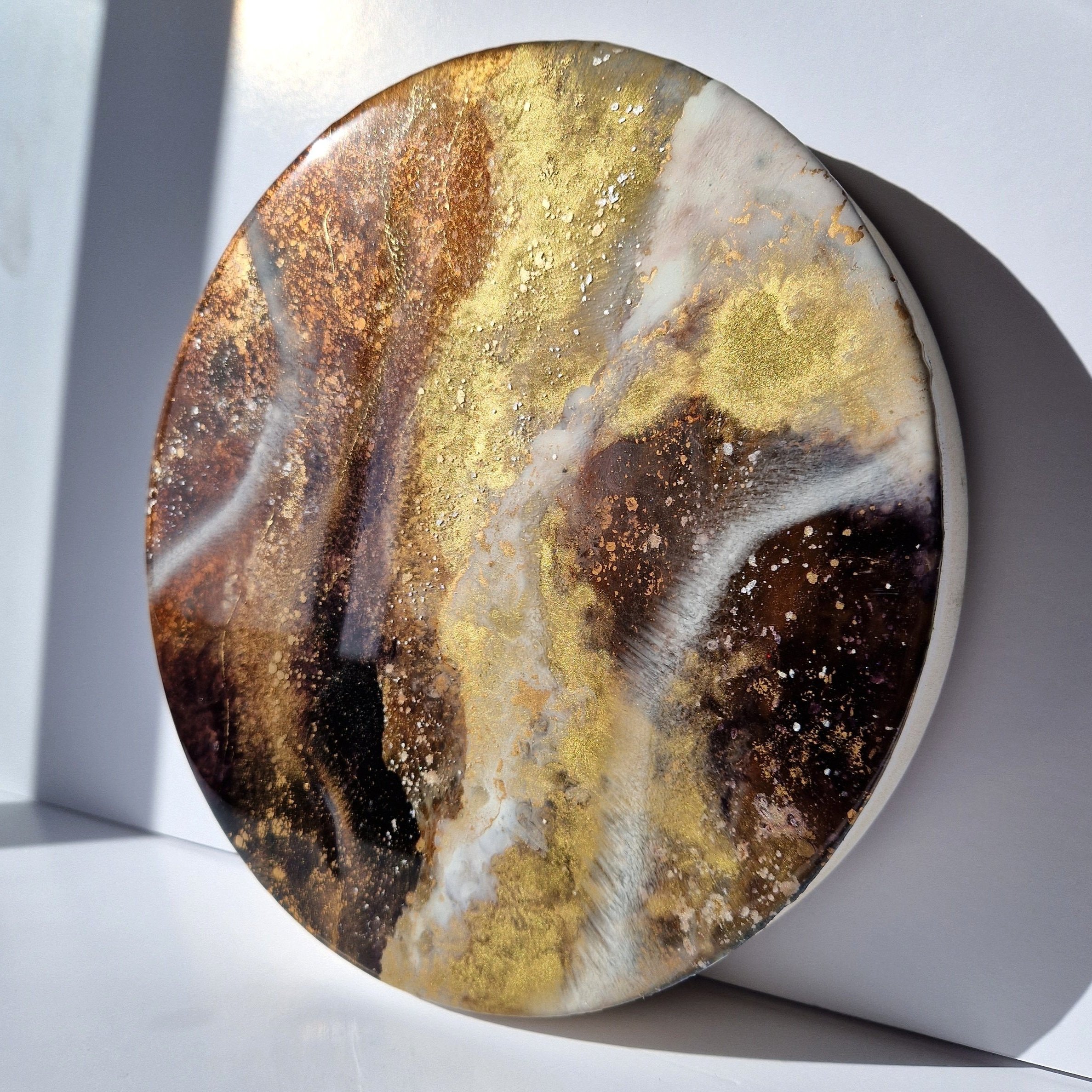 Coffee inspired round wall art inspired by the rich, warm hues of coffee. The piece is made from resin and mixed media materials. Perfect coffee painting for a coffee lover.