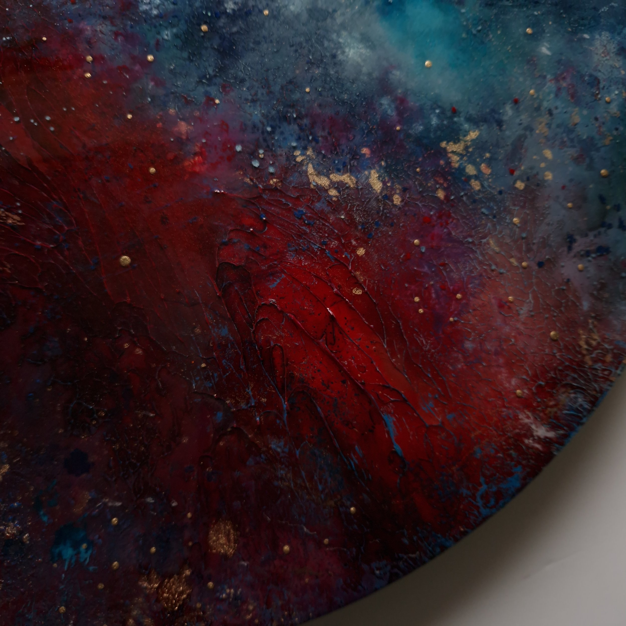 Red and blue dramatic abstract resin round wall art by UK artist Katie Alize