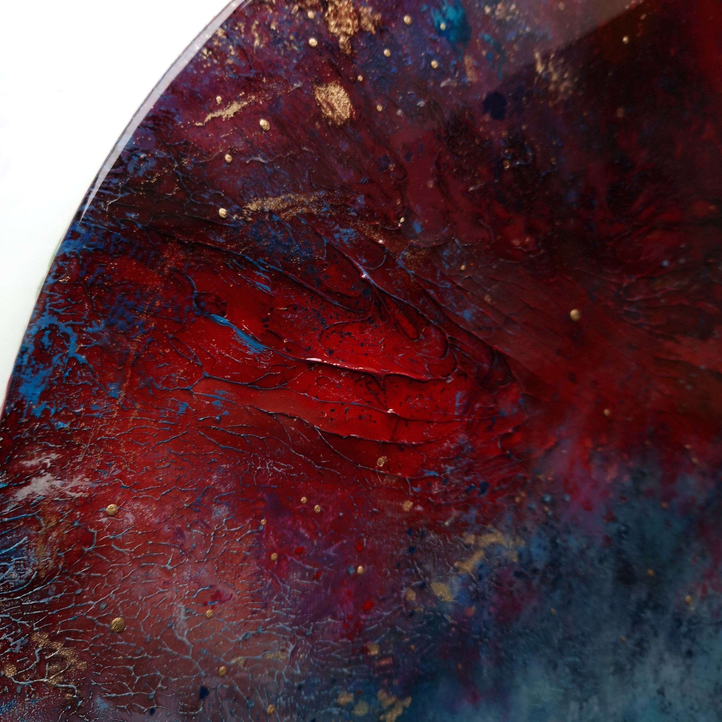Red and blue dramatic abstract resin round wall art by UK artist Katie Alize