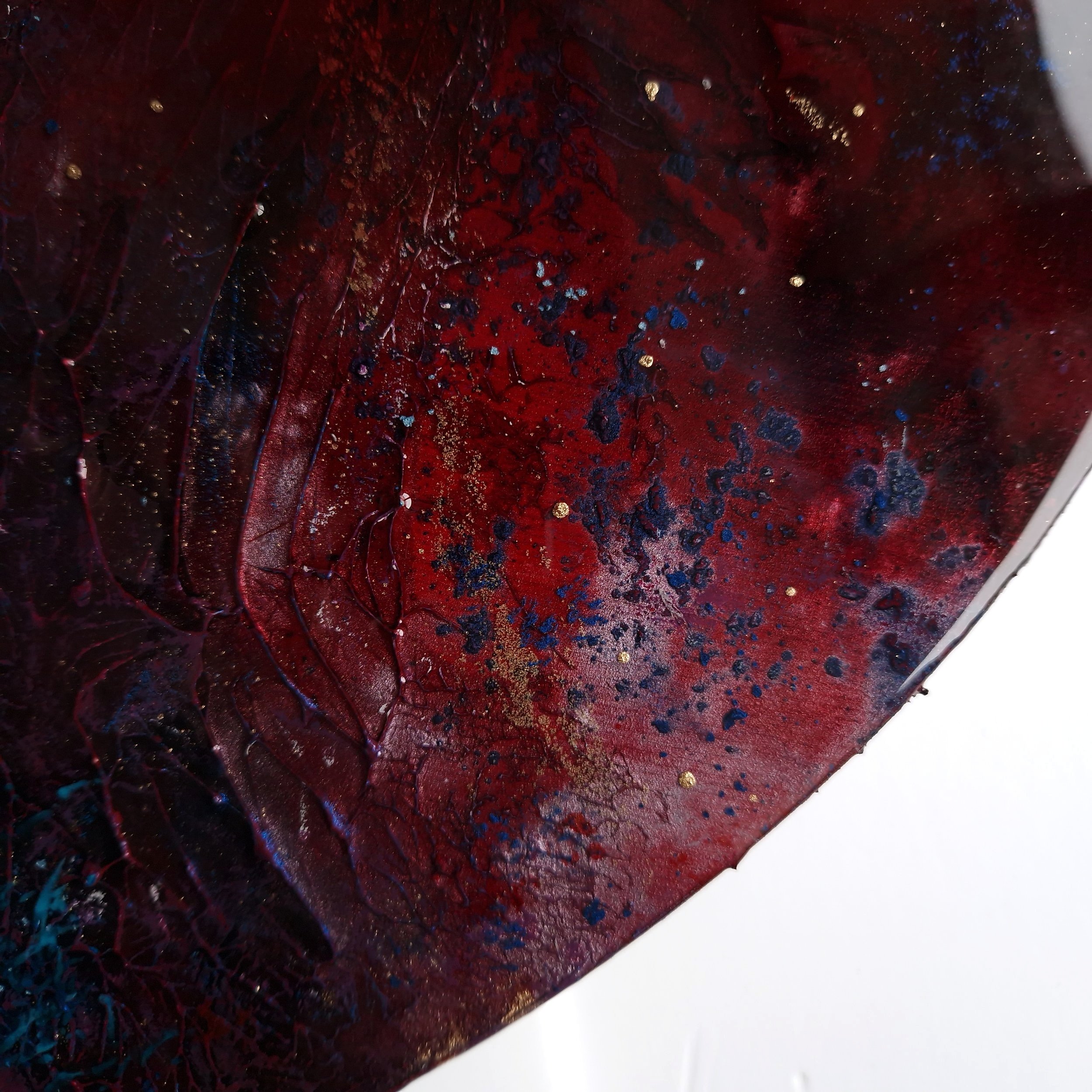 Red and blue dramatic abstract resin round wall art by UK artist Katie Alize
