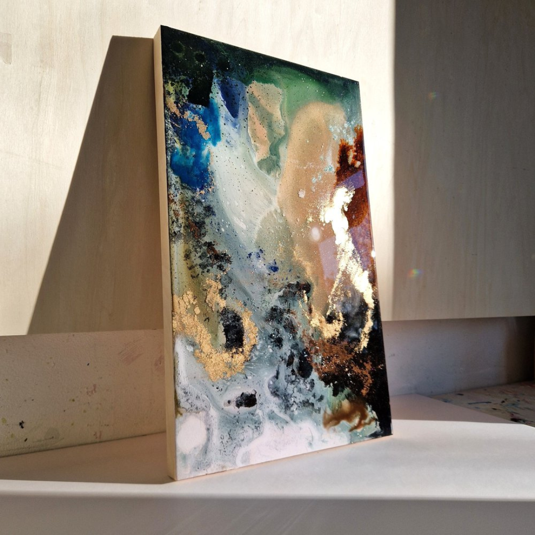 Abstract fluid art painting with blue, green, white, black, and gold colors on canvas.  Abstract resin mixed media artwork created by UK based artist Katie Alize