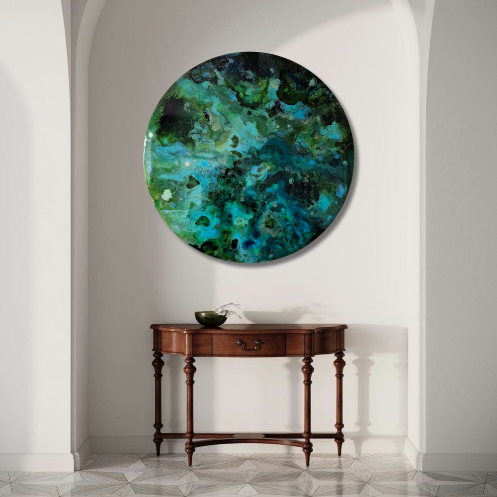 Katie Alize holding a colourful abstract resin forest inspired commission painting with green, yellow, and brown hues.