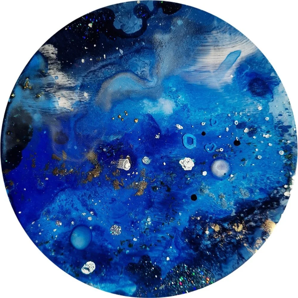 Circular blue resin abstract art with shades of blue, white, and black, ocean resin art, ocean epoxy art, ocean art, coastal decor, coastal art. Original bespoke abstract artwork created by artist Katie Alize, based in UK, Essex, London.