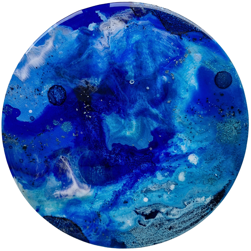 Circular blue resin abstract art with shades of blue, white, and black, resembling space or ocean scenes with swirling patterns and specks of white. Original bespoke abstract artwork created by artist Katie Alize, based in UK, Essex, London.