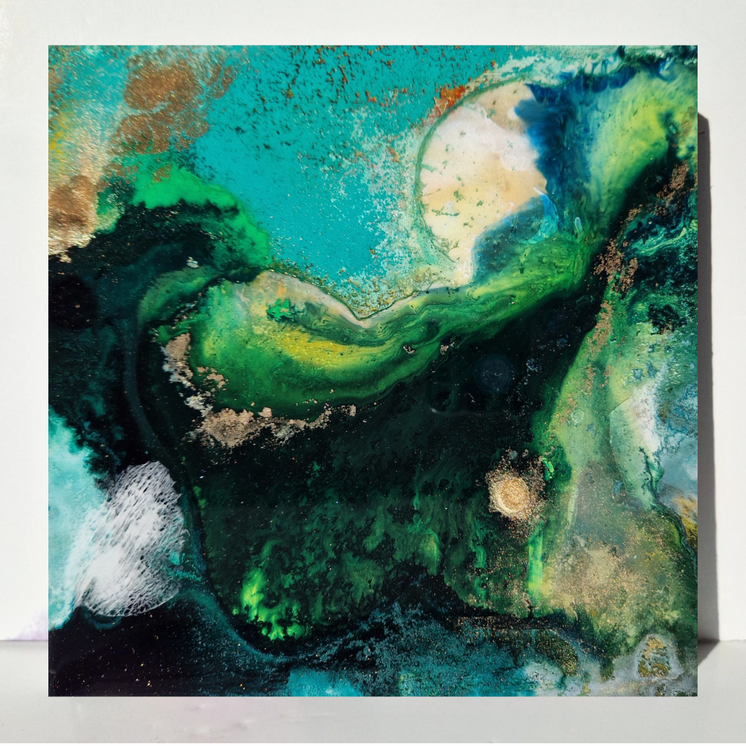 Abstract painting with vibrant green, yellow, brown, blue, and black colors, featuring textured patterns and small splatters. Abstract epoxy resin circular painting with splashes of green, blue, brown, black, and white. Abstract forest