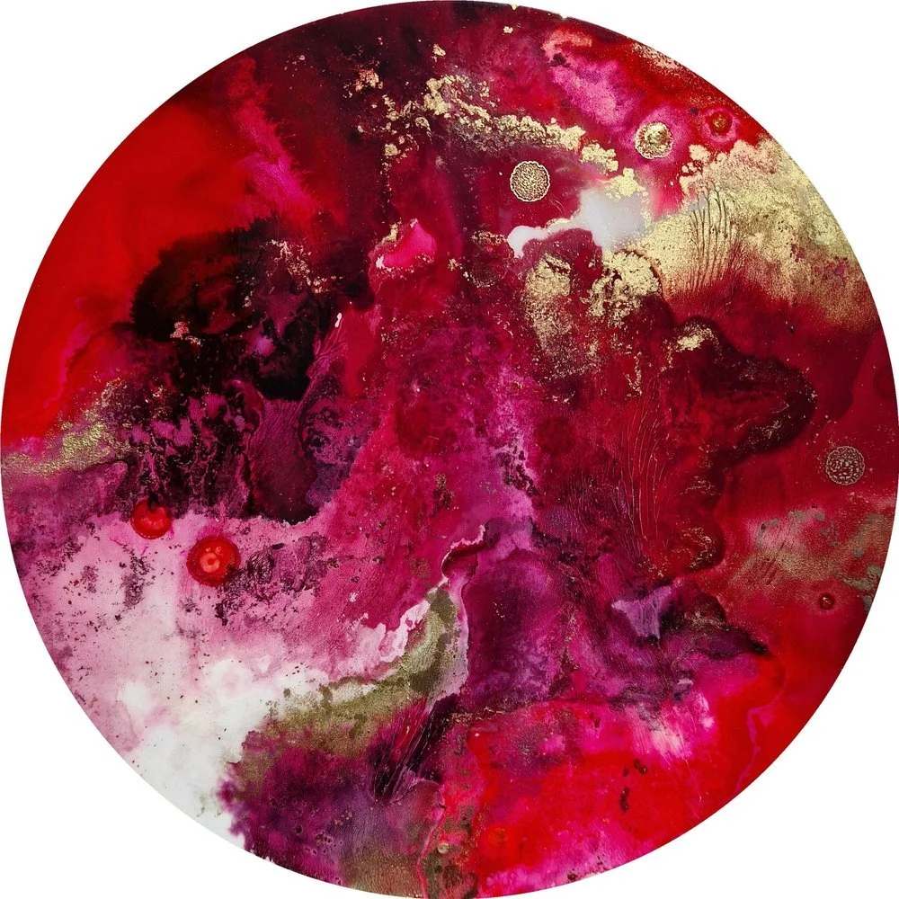 Abstract circular artwork with red, pink, white, black, and gold colors blending and swirling together. Abstract resin and ink circular painting with red, pink, orange, black, and white colours. Feminine artwork, female rage artwork, female cycle art