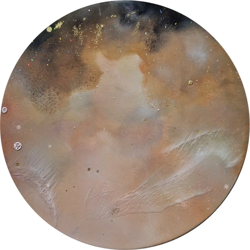 A circular painted and resin mixed media gold abstract art piece with black, brown, gray, and gold splatters and textures. Abstract luxury gold resin mixed media artwork created by UK based artist Katie Alize