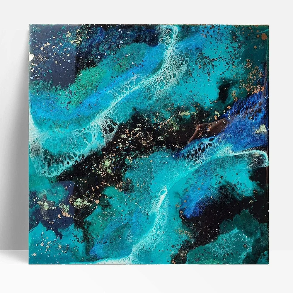Circular blue resin abstract art with shades of blue, white, and black, ocean resin art, ocean epoxy art, ocean art, coastal decor, coastal art. Original bespoke abstract artwork created by artist Katie Alize, based in UK, Essex, London.