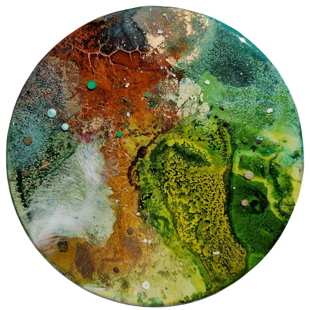 Abstract circular painting with vibrant green, yellow, brown, blue, and black colors, featuring textured patterns and small splatters. Abstract epoxy resin circular painting with splashes of green, blue, brown, black, and white. Abstract forest