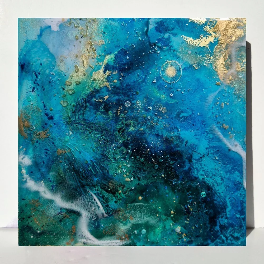 Circular blue resin abstract art with shades of blue, white, and black, ocean resin art, ocean epoxy art, ocean art, coastal decor, coastal art. Original bespoke abstract artwork created by artist Katie Alize, based in UK, Essex, London.