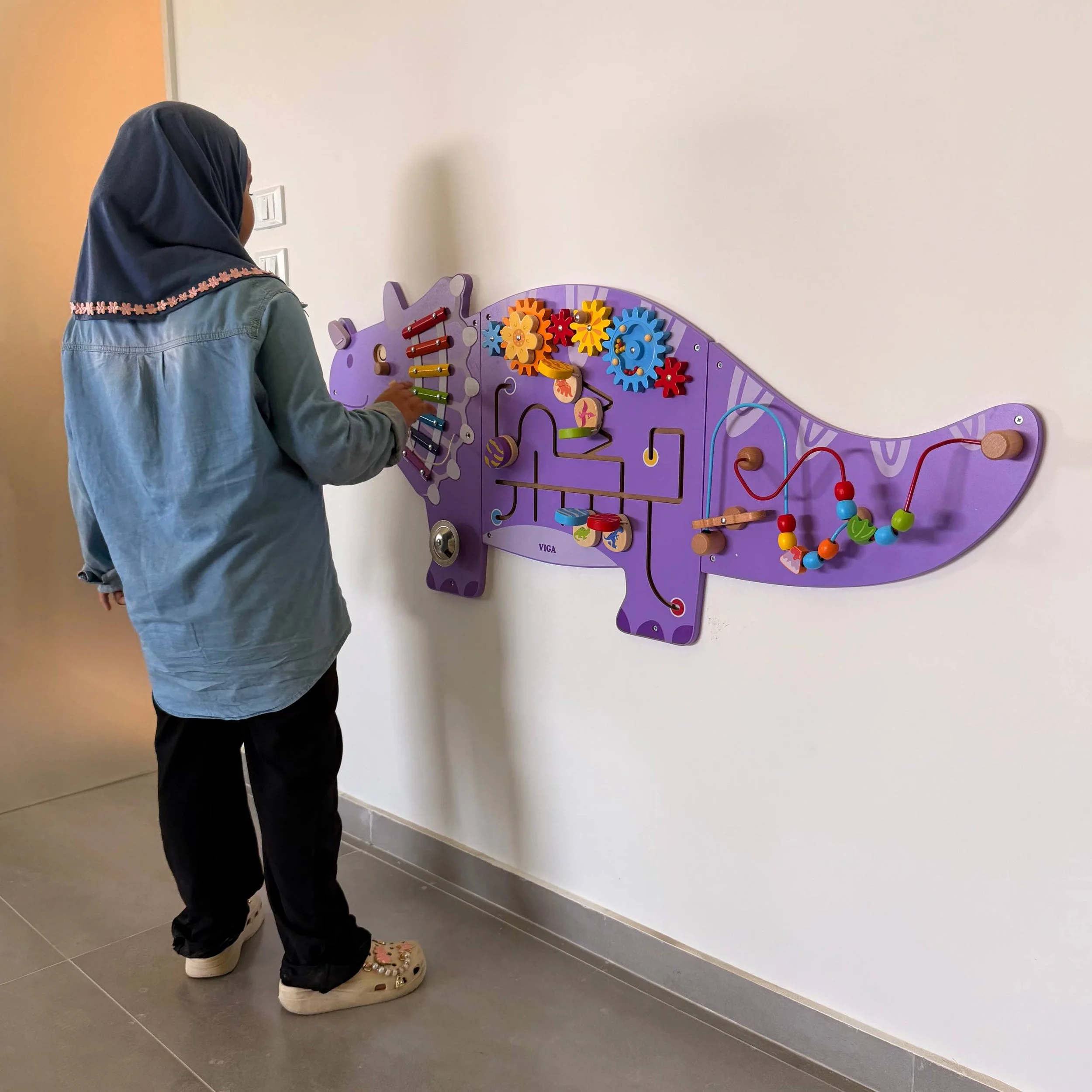 Student Interacting with Full Dinosaur Busyboard