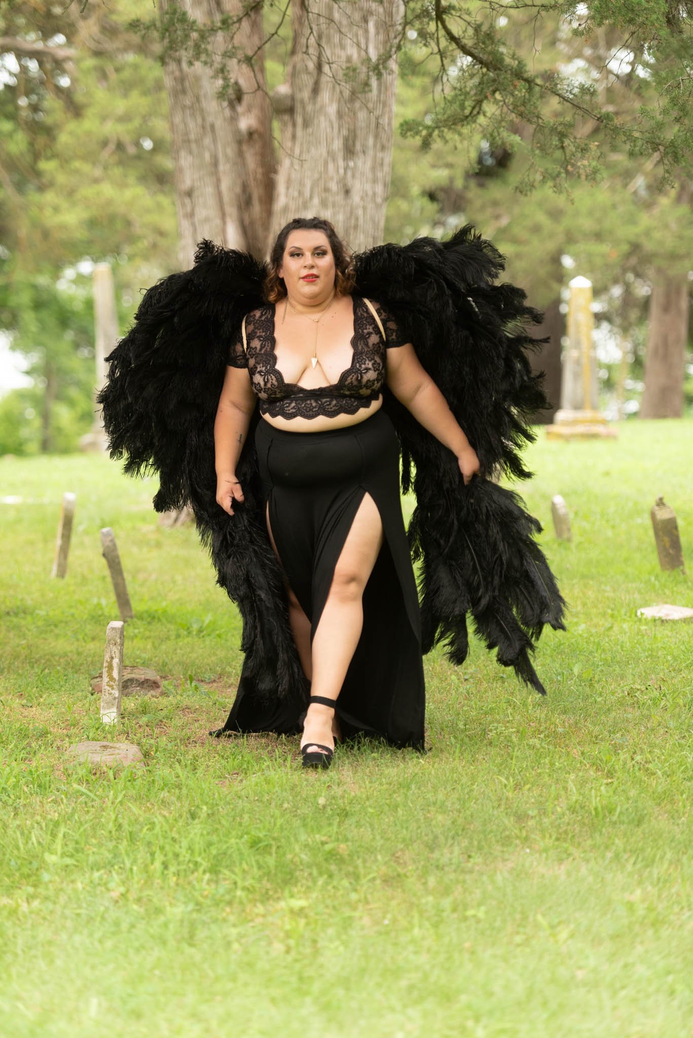  Samantha in black dress and black angel wings poses in cemetery. 