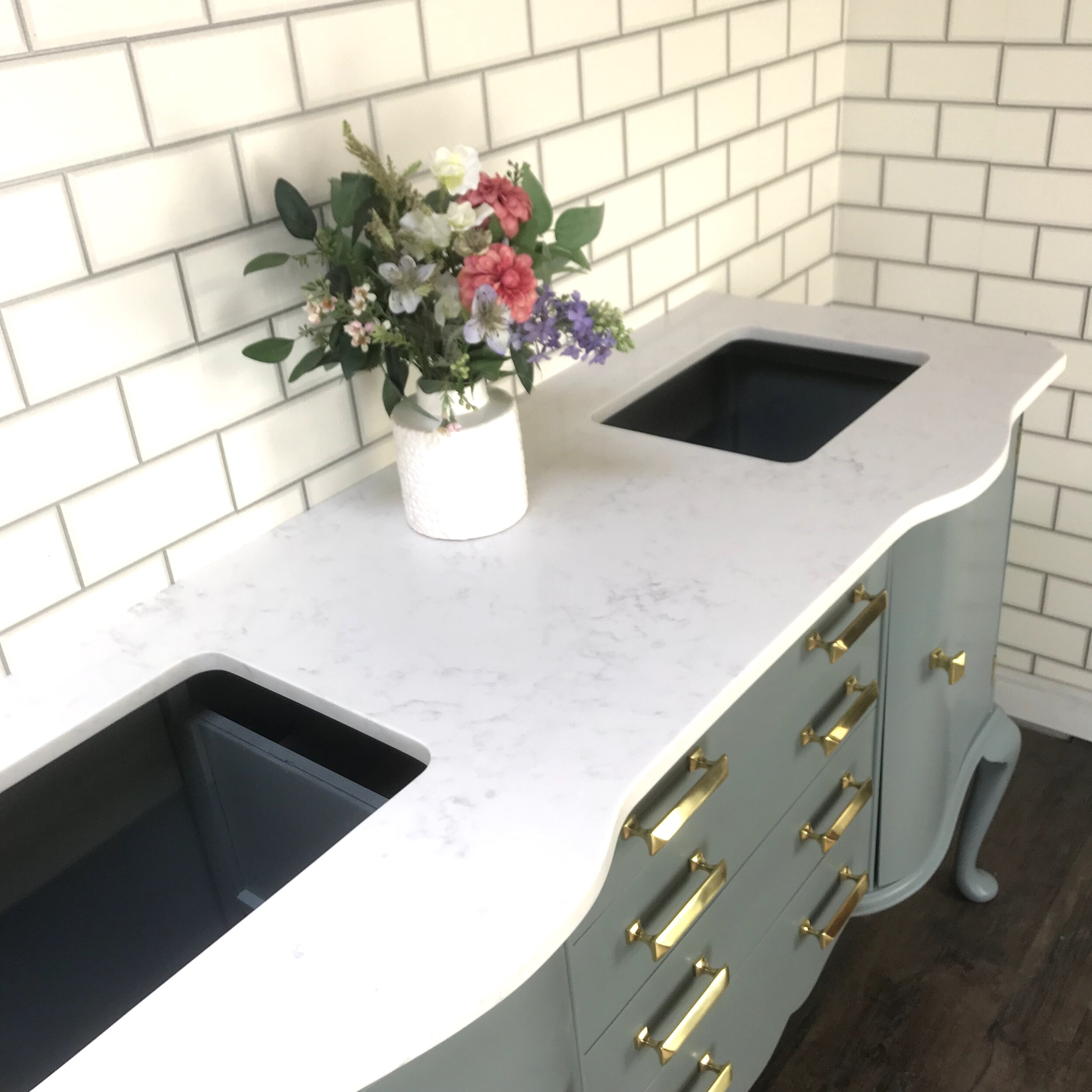 Cararra Quart Countertop with serpentine front and under-mounted basin openings