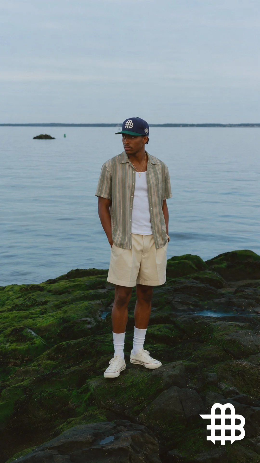Black Male Standing On Rocks With Rare Marlin_.jpg
